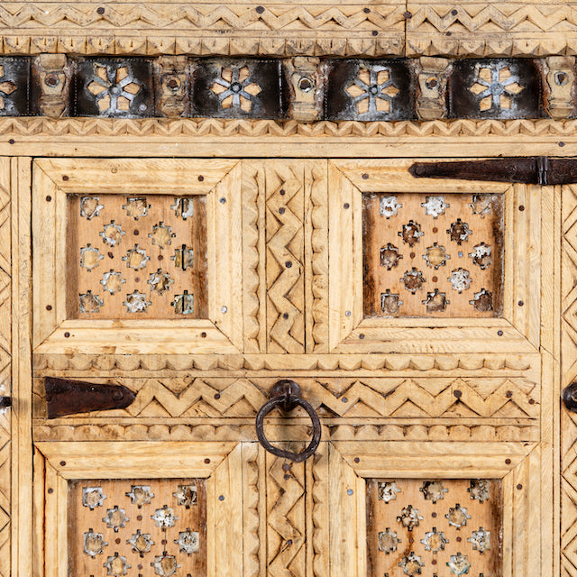 Close up image of a vintage entryway table treasure chest in antique Indian furniture style, solid teak wood with iron accents and sandblasted finish, 113 × 54 × 100 cm.