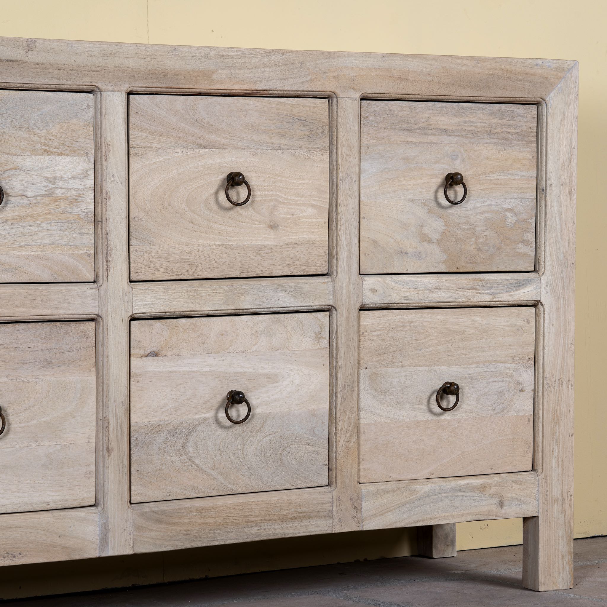 Close up image of a sandblasted reclaimed mango wood chest of drawers with ten drawers, perfect as bedroom furniture or part of a relaxed Ibiza-style interior.