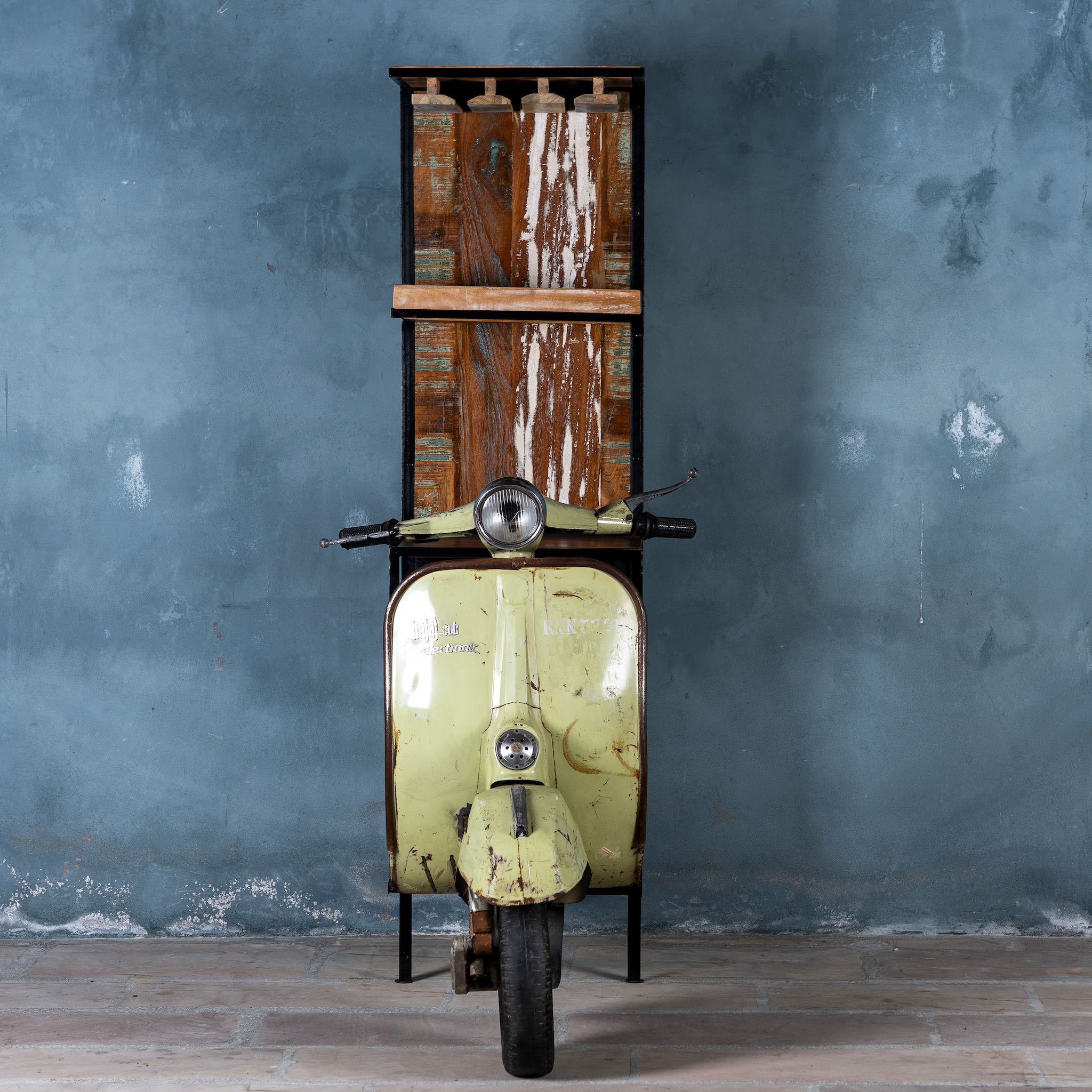 Front part image of Ahana high bar table featuring the front half of a vintage Bajaj scooter, with tall wooden shelving and an industrial metal frame, designed for stylish bar storage.