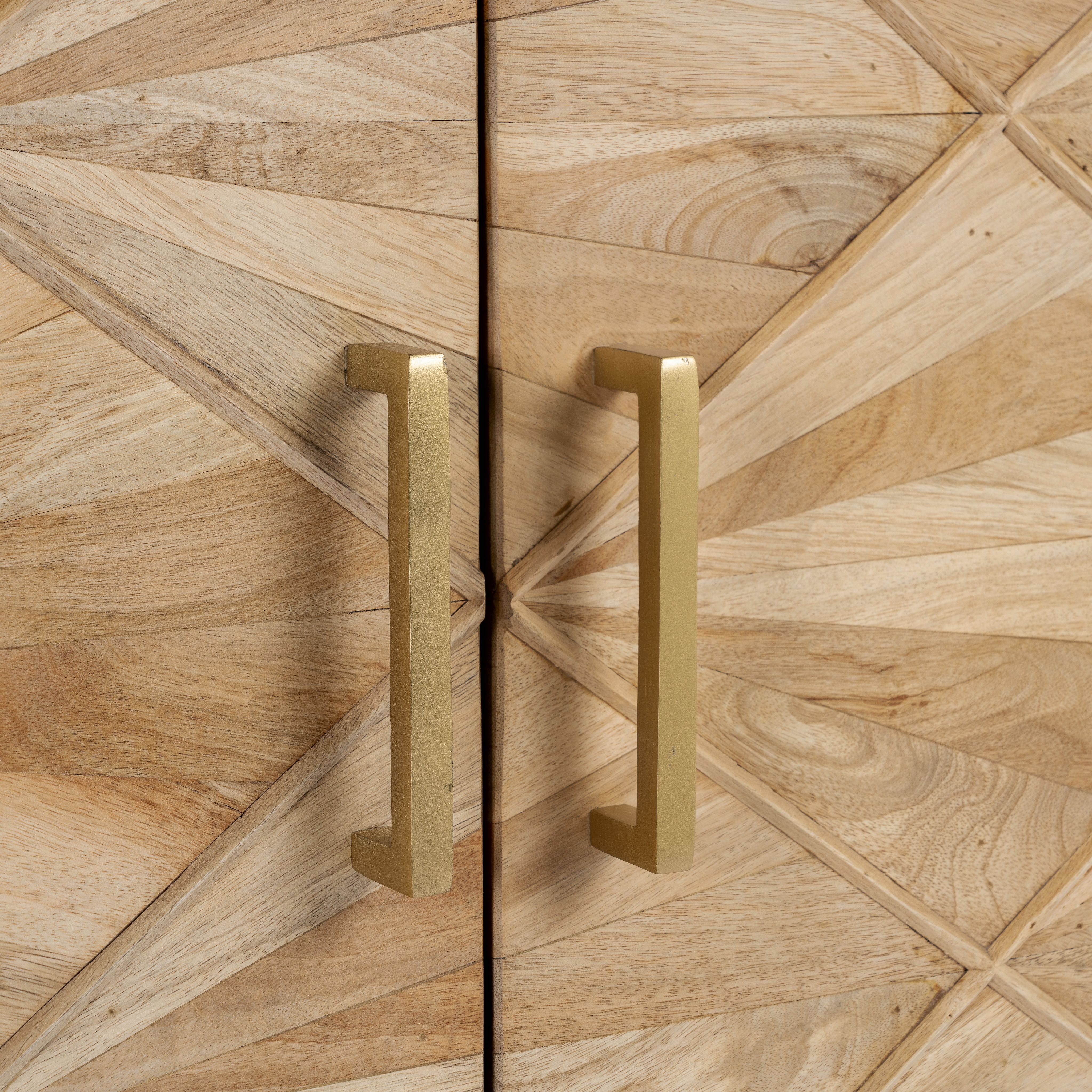 Close up image of a handcrafted mango wood sideboard with star-carved doors and brass-plated iron stand—an artisanal furniture piece blending minimalistic and rustic design elements.