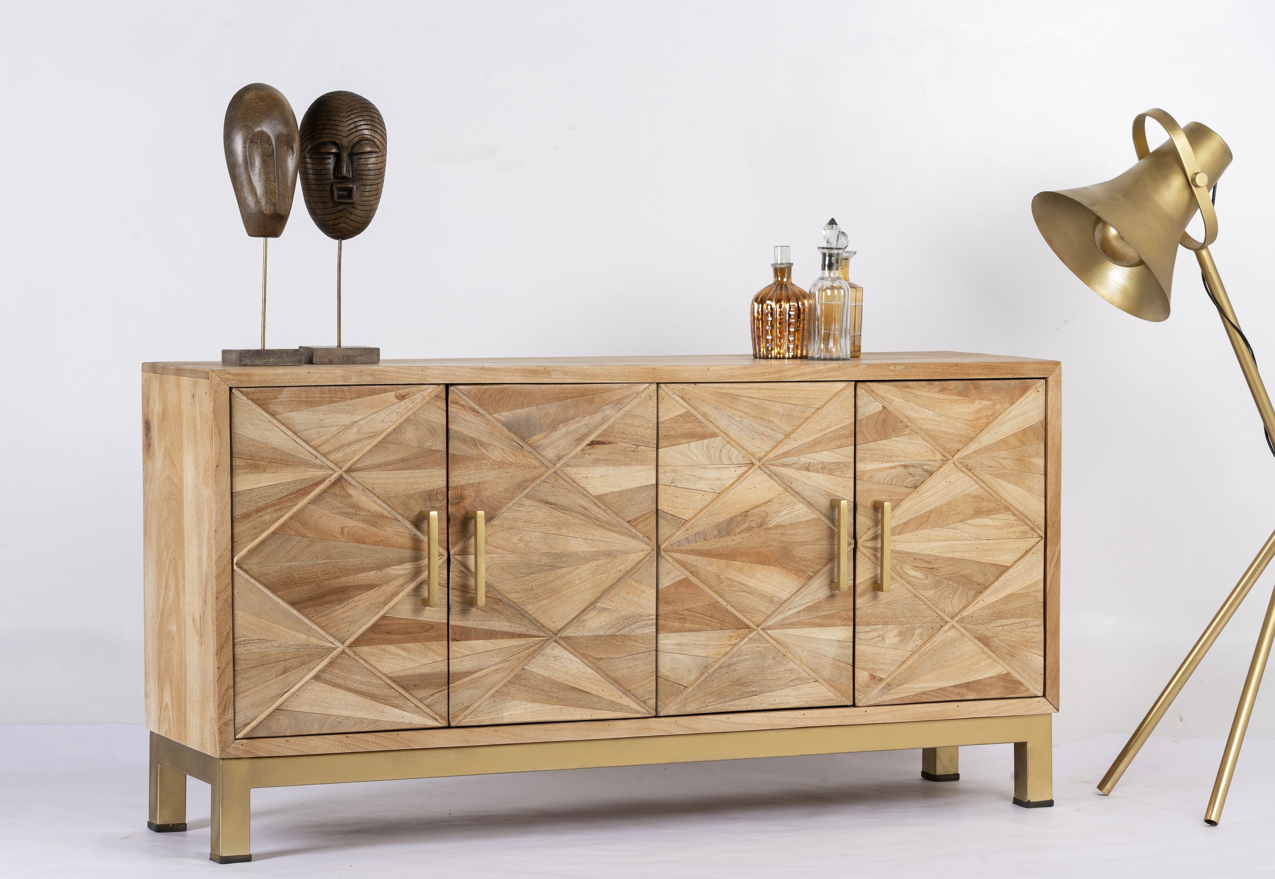 Side angle image of a handcrafted mango wood sideboard with star-carved doors and brass-plated iron stand—an artisanal furniture piece blending minimalistic and rustic design elements.