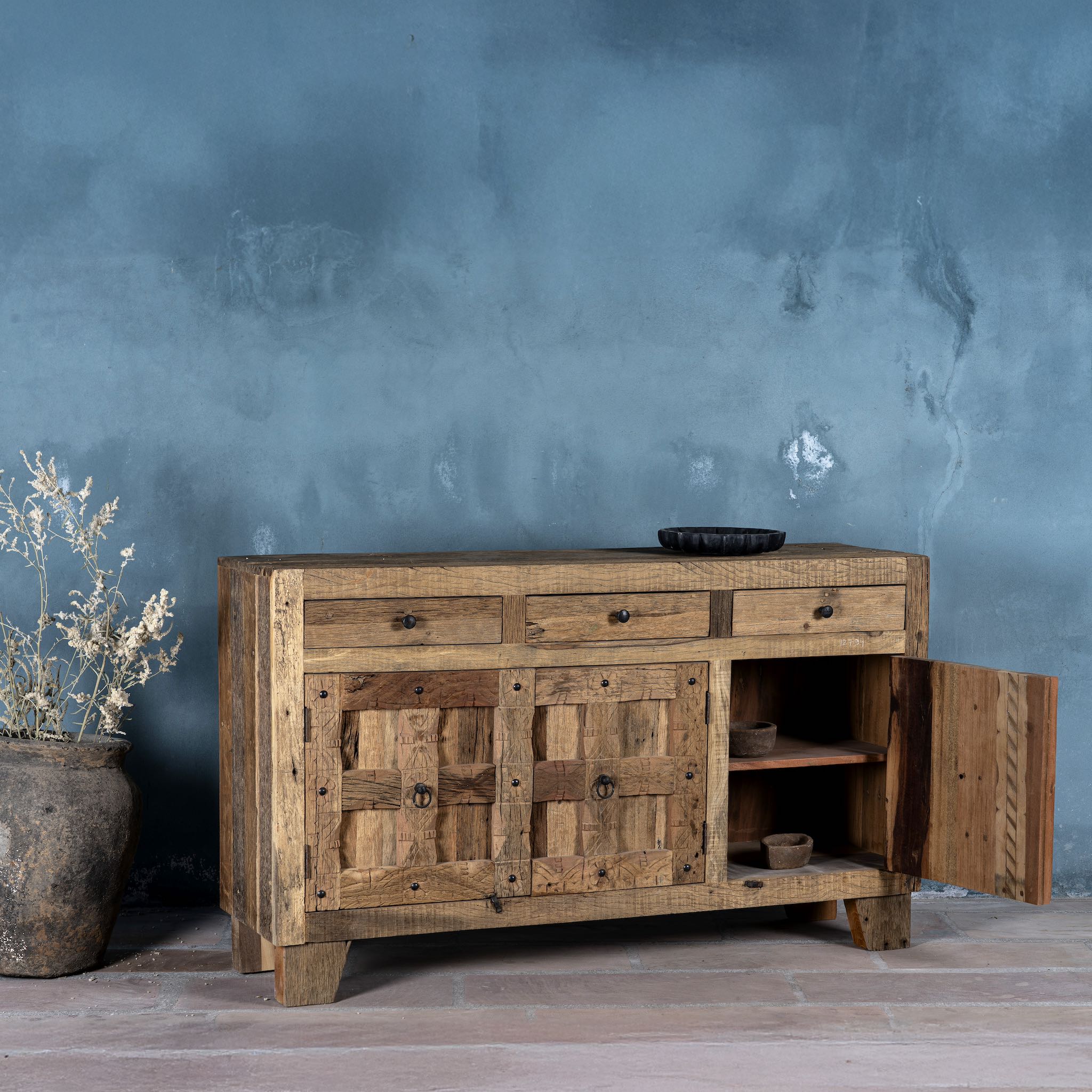 Open door image of a rustic design sideboard made from reclaimed wood with panelled doors, drawers, and iron accents; 150 × 40 × 90 cm.