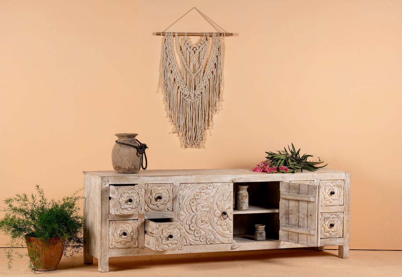 Open door and drawer image of a whitewashed mango wood lowboard with hand-carved floral details, eight drawers and two compartments; ideal as a wooden lowboard or carved wood console table, 180 × 60 × 40 cm.