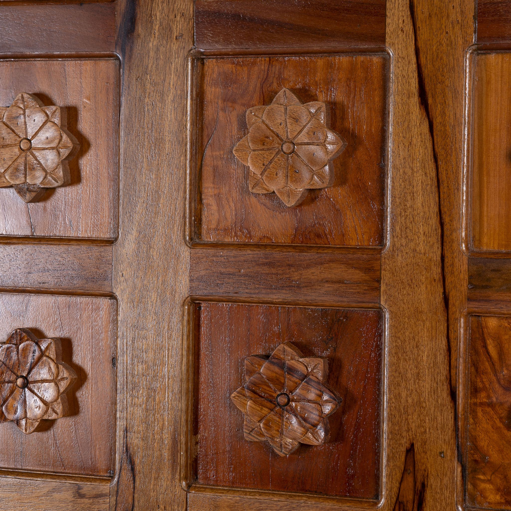 Close-up of a wooden panel with floral carvings
