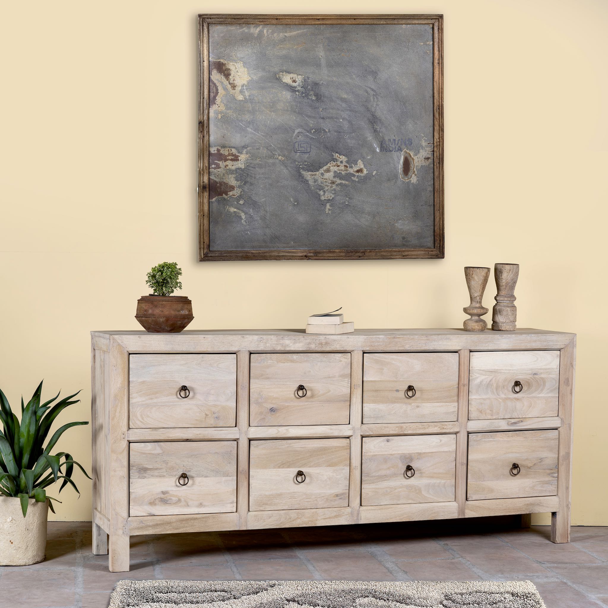 Side angle image of a Ibiza style chest of drawers made from sandblasted reclaimed wood, coastal furniture with 8 drawers and vintage metal pulls, 200 × 40 × 90 cm.