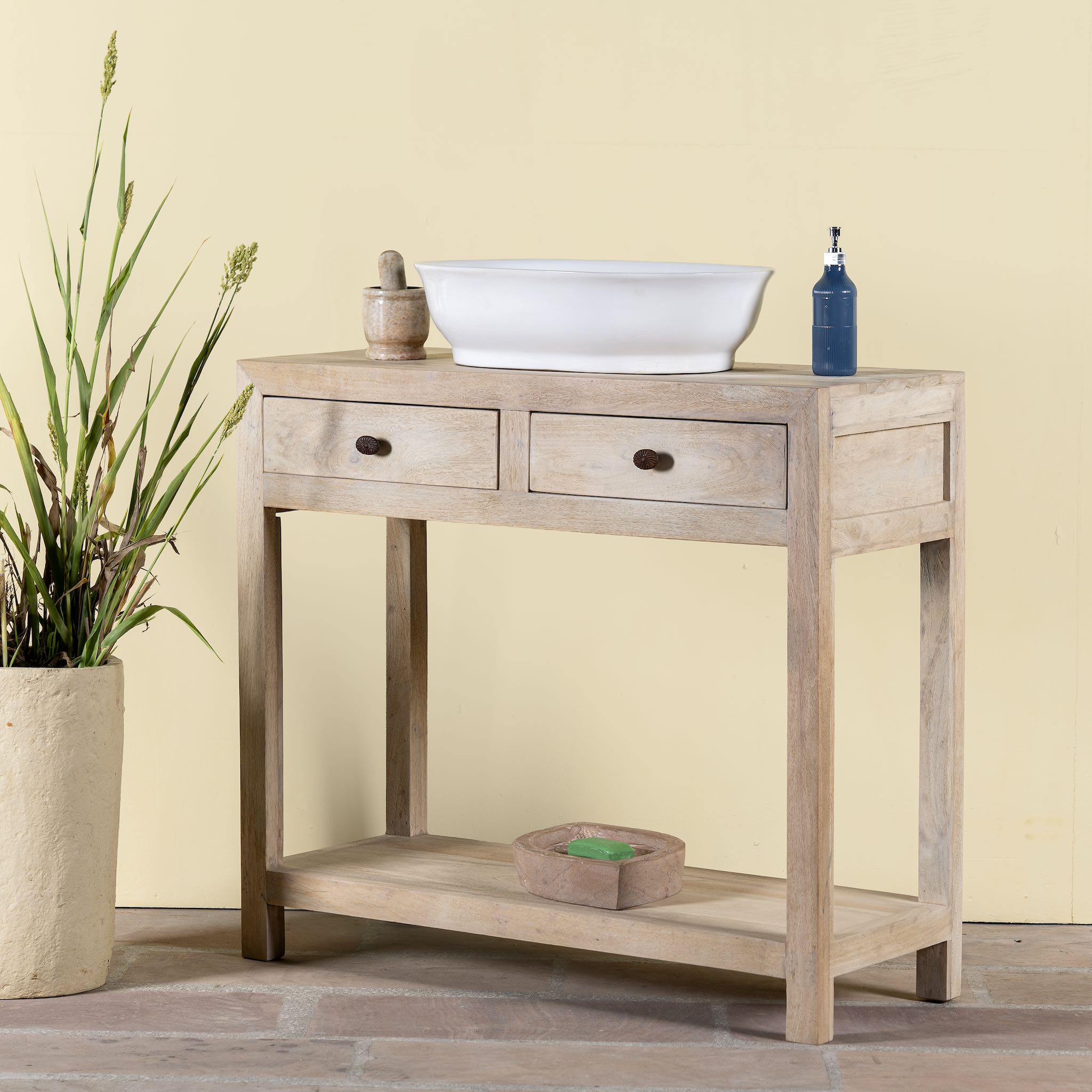 Side angle image of a Ibiza style reclaimed wood console table with two drawers and a lower shelf, whitewashed finish, 100 × 40 × 90 cm.