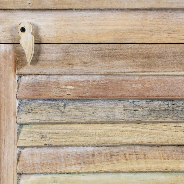 Close up image of a reclaimed teak wood cabinet with slatted door and sandblasted finish, Ibiza-style, 122 × 56 × 40 cm.