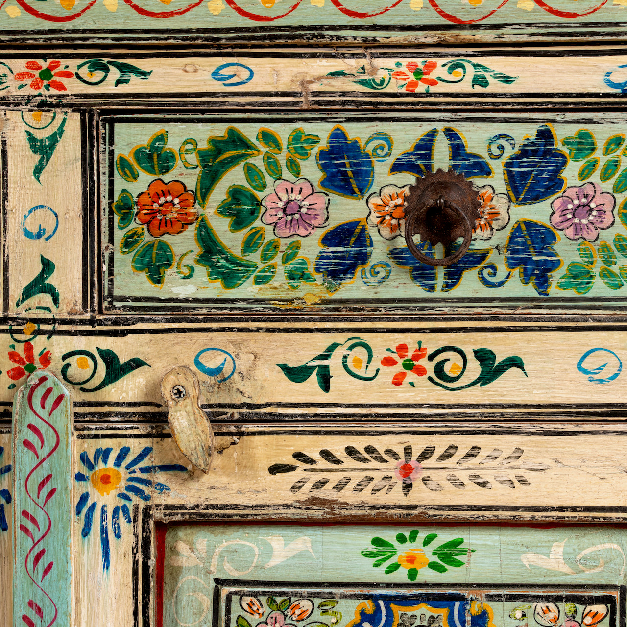 Close up image of a hand painted cabinet made from reclaimed wood with colourful traditional Indian motifs, 90 × 90 × 40 cm.