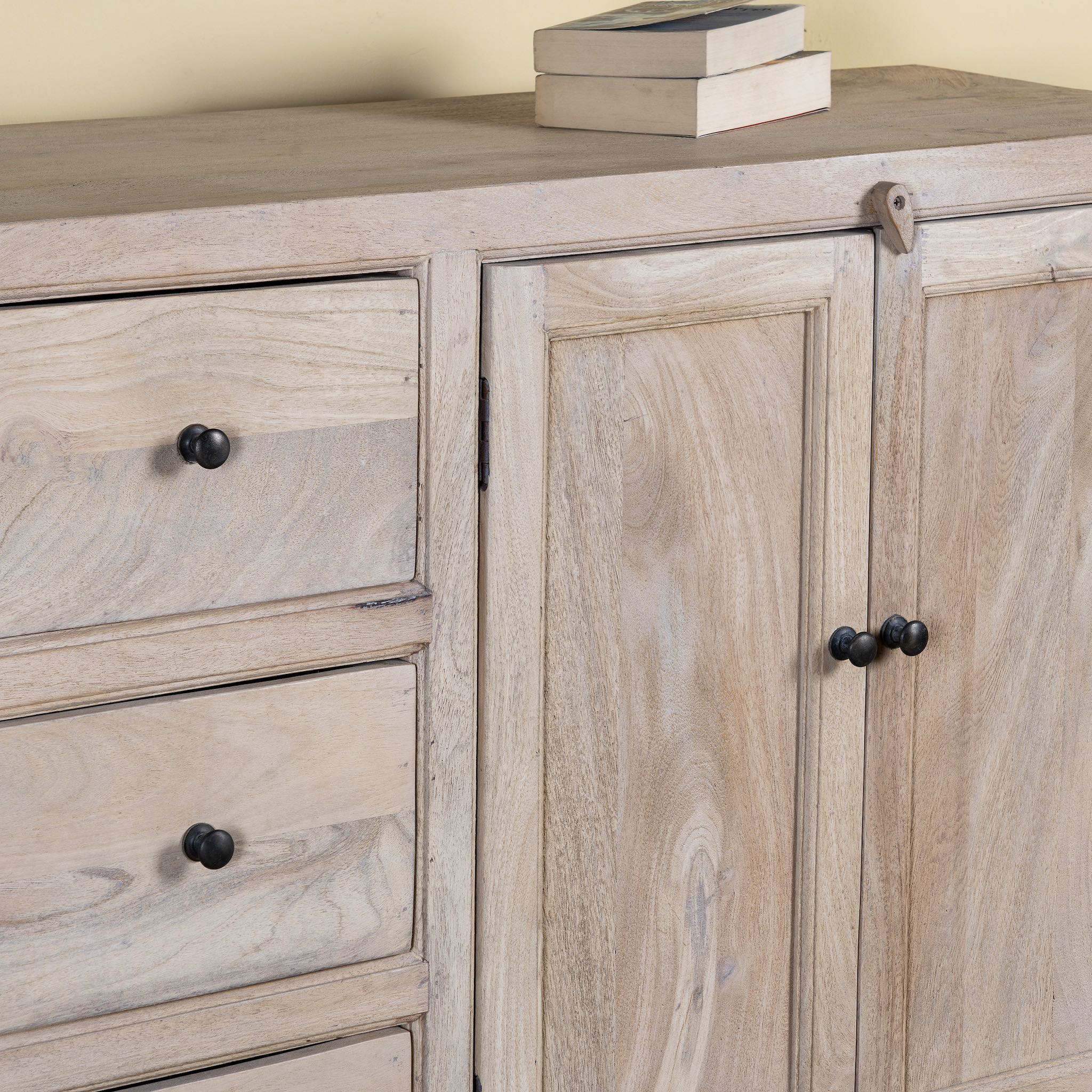 Close up image of a sandblasted wood sideboard with drawers and cabinets, living room furniture in relaxed Ibiza style.