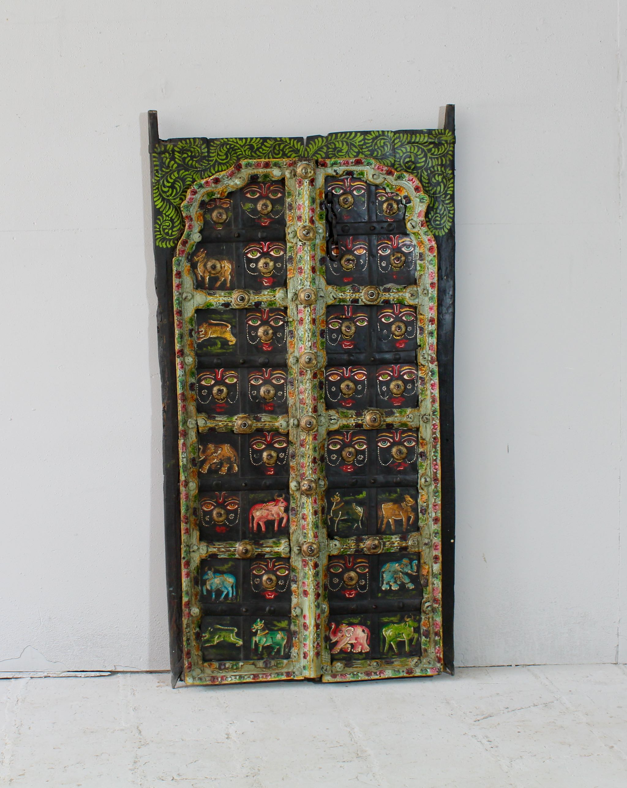 Hand-painted Indian antique teak door panel with sacred animal motifs and face masks, vintage wall panels repurposed as home decor.