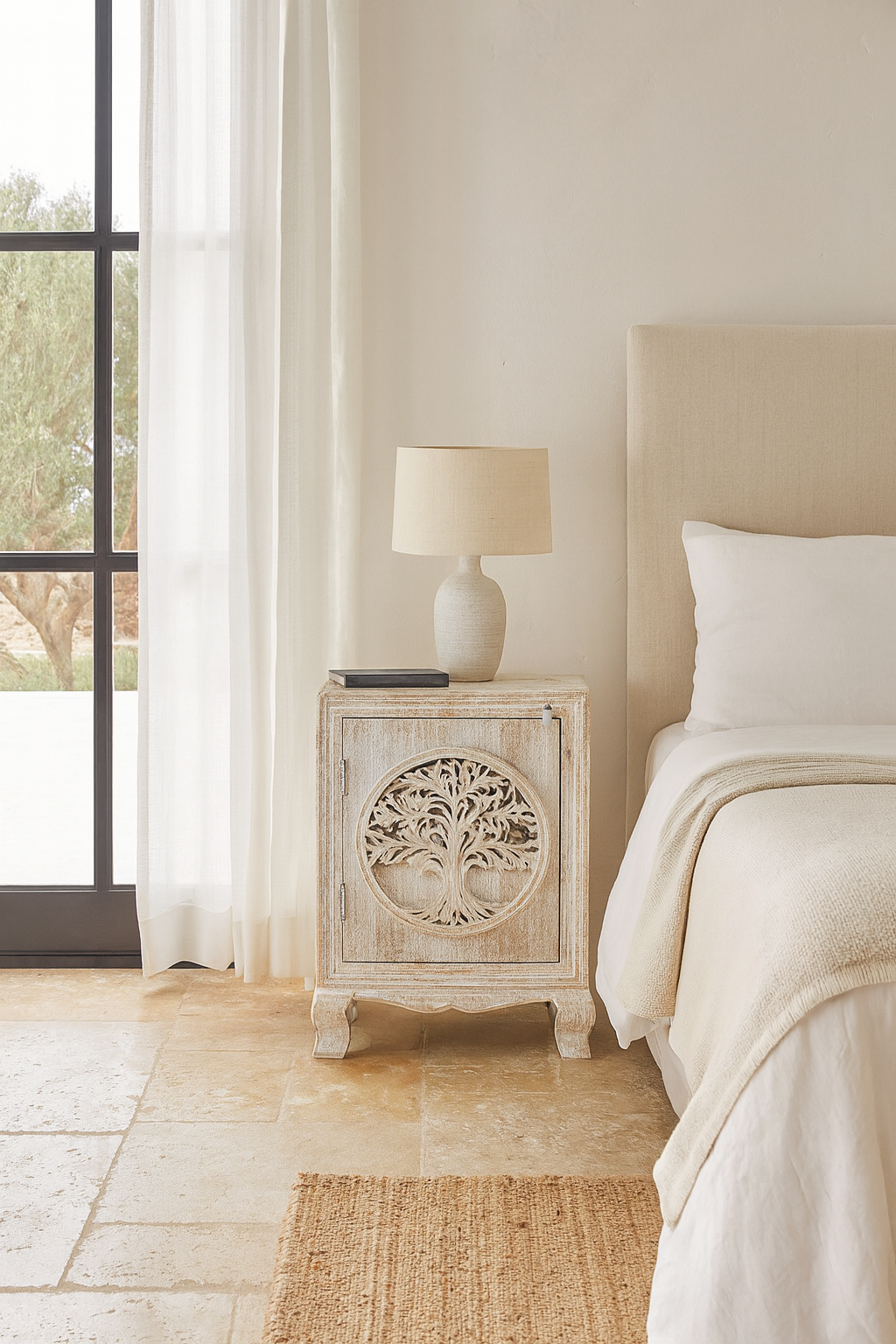 Lifestyle scene of a pair of mango wood bedside tables with hand-carved tree motifs and antique finish; perfect bedroom furniture and mango wood furniture, 50 × 70 × 40 cm.