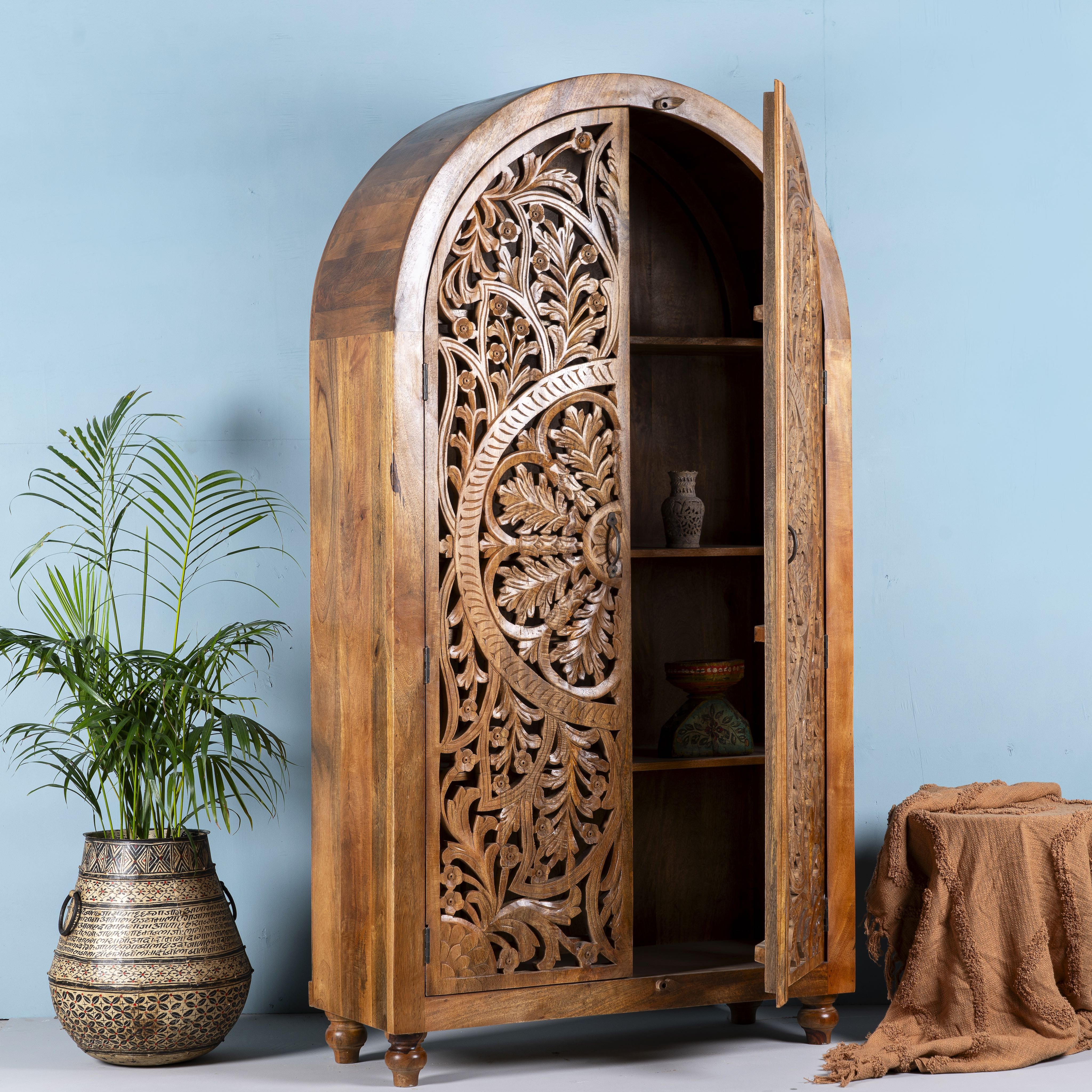 Open door image of a unique wooden wardrobe made from solid mango wood with hand-carved floral design and rounded shape, 100 × 40 × 190 cm.