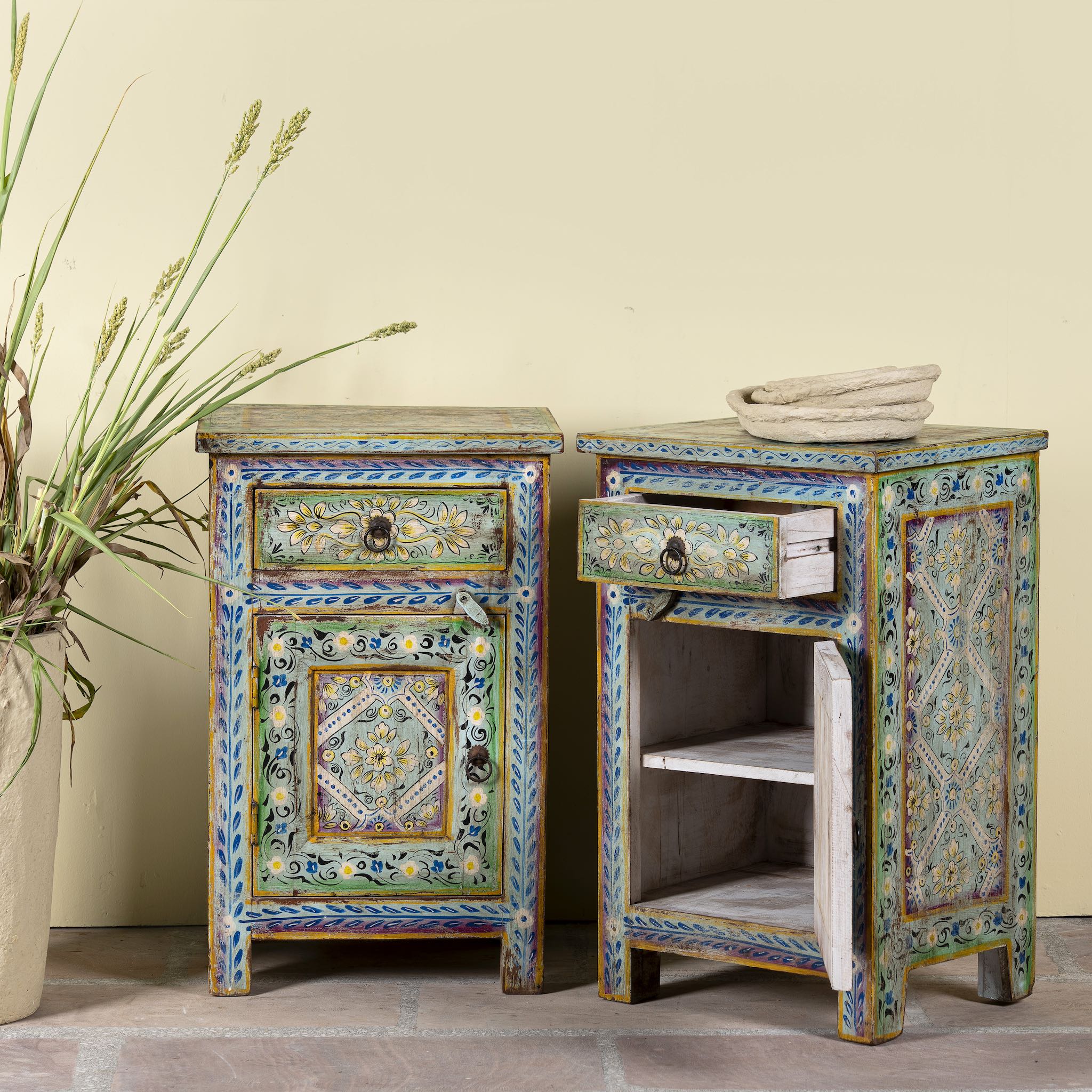 Open door image of a pair of hand-painted nightstands made of reclaimed wood in boho style, sustainable furniture with drawer and cabinet, 45 × 35 × 70 cm.