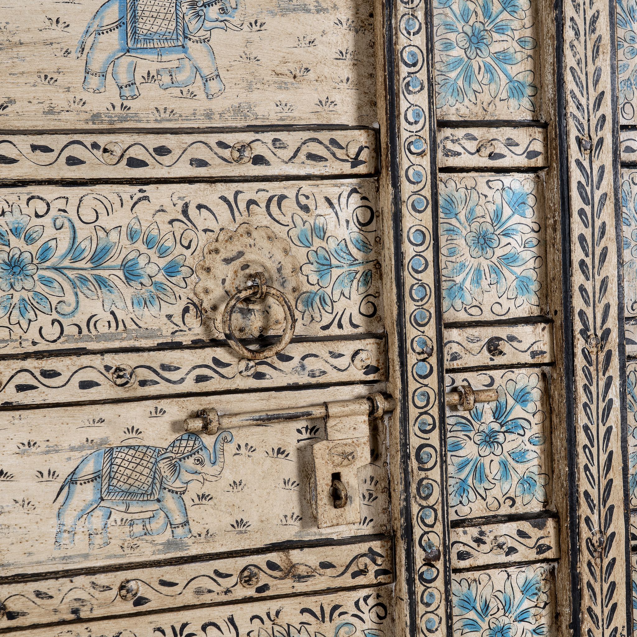 Close up image of an antique hand-painted Indian teak wood door with floral and elephant motifs; vintage Indian doors for wooden wall decoration, 128 × 10 × 250 cm.
