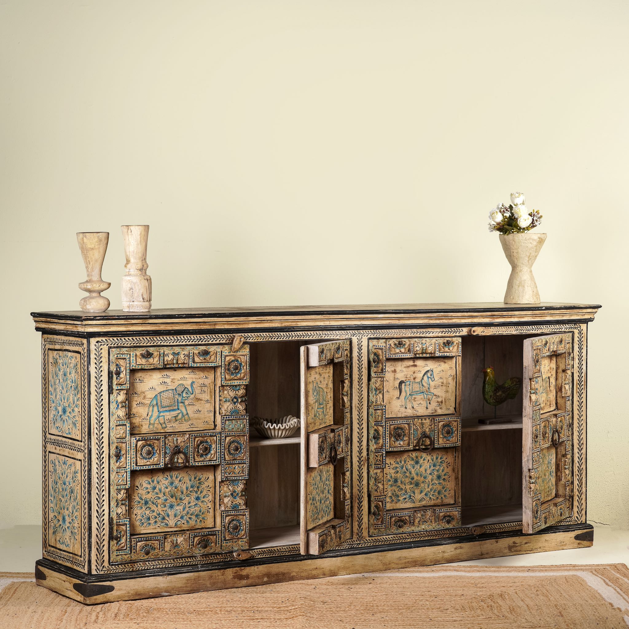 Open door image of a unique sideboard made of recycled wood with hand painted Indian motifs in blue and gold; sustainable furniture for dining rooms or hallways, 220 × 44 × 98 cm.