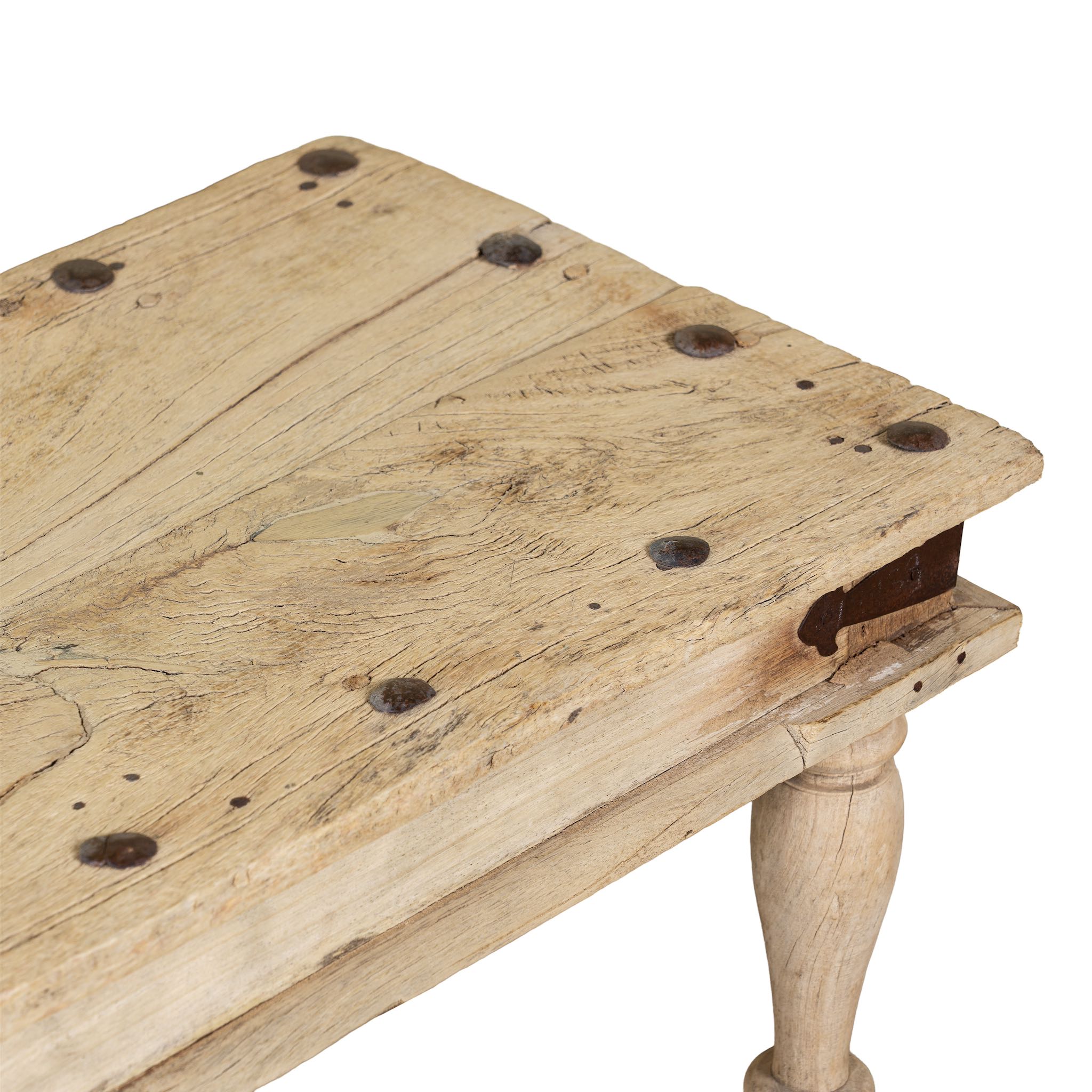 Close up image of a sandblasted reclaimed teak bench with turned legs, rustic finish; unique teak furniture, 152 × 40 × 44 cm.