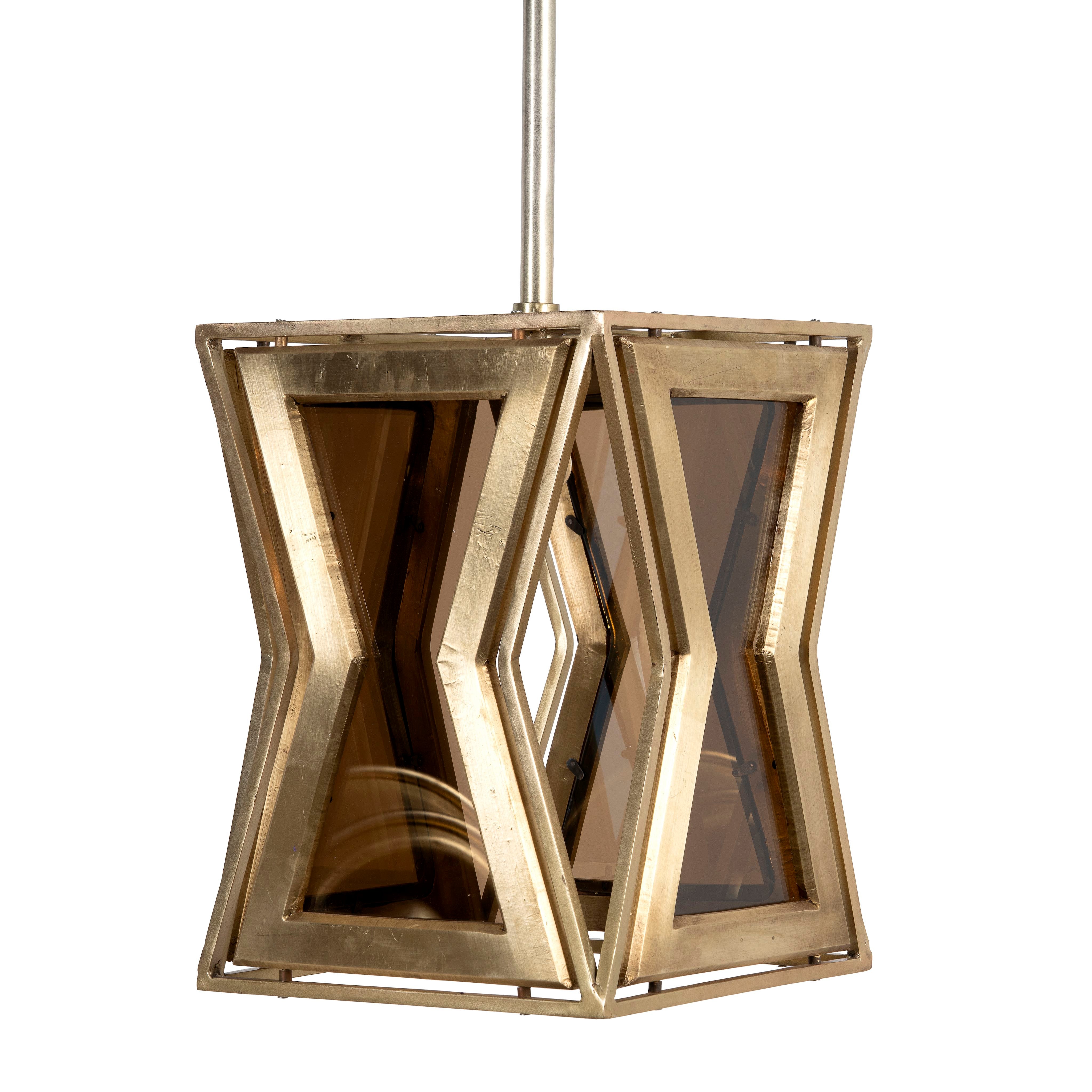 A contemporary style pendant lamp with a tapered design, featuring a combination of wood and brass materials, and tinted glass panels.