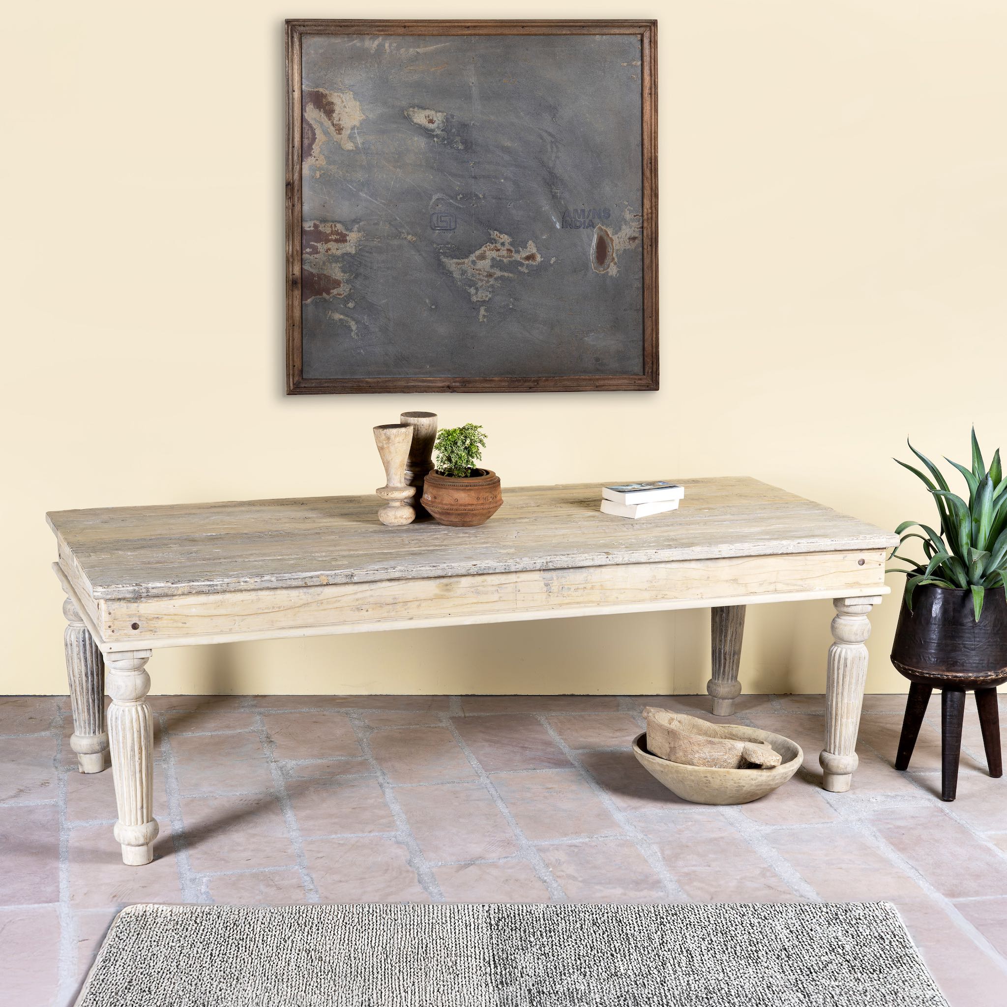 Side angle image of a sandblasted reclaimed wood dining table with carved legs, sustainable dining room furniture, 220×100×75 cm.