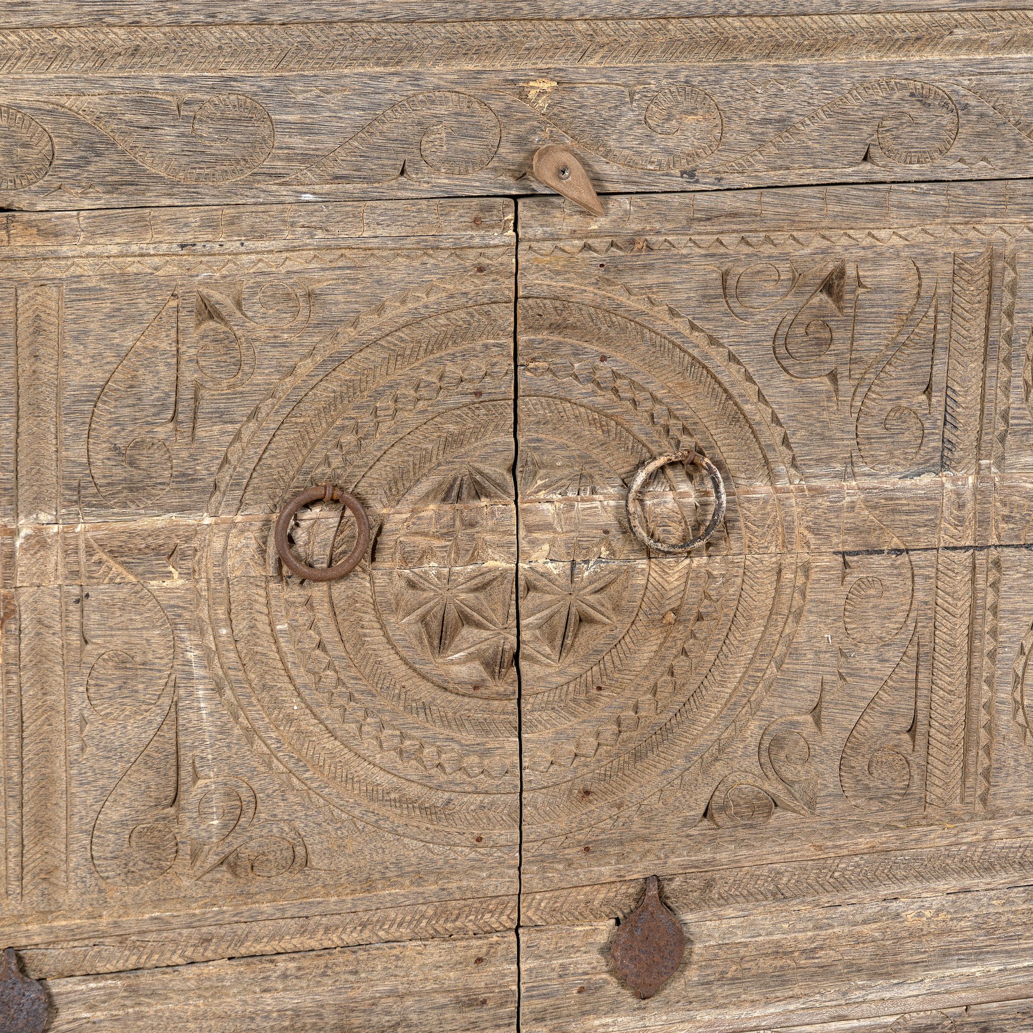 Close up image of Etasha, a reclaimed wood sideboard made from antique teak doors with carved detailing; teak furniture, 130 × 38 × 83 cm.