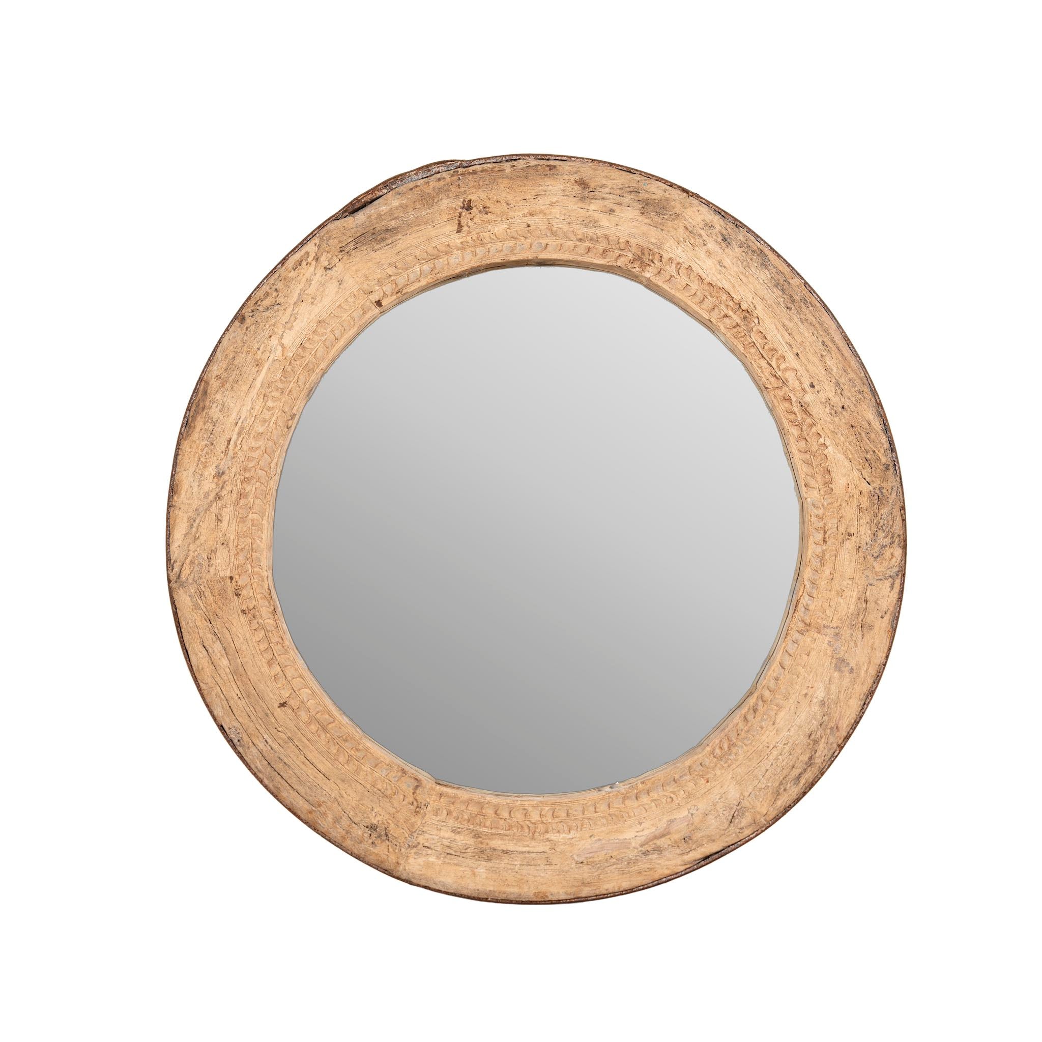White background image of a round carved wooden mirror with reclaimed teak frame and rustic iron edging; Indian furniture online, 110 cm diameter, 8 cm deep.
