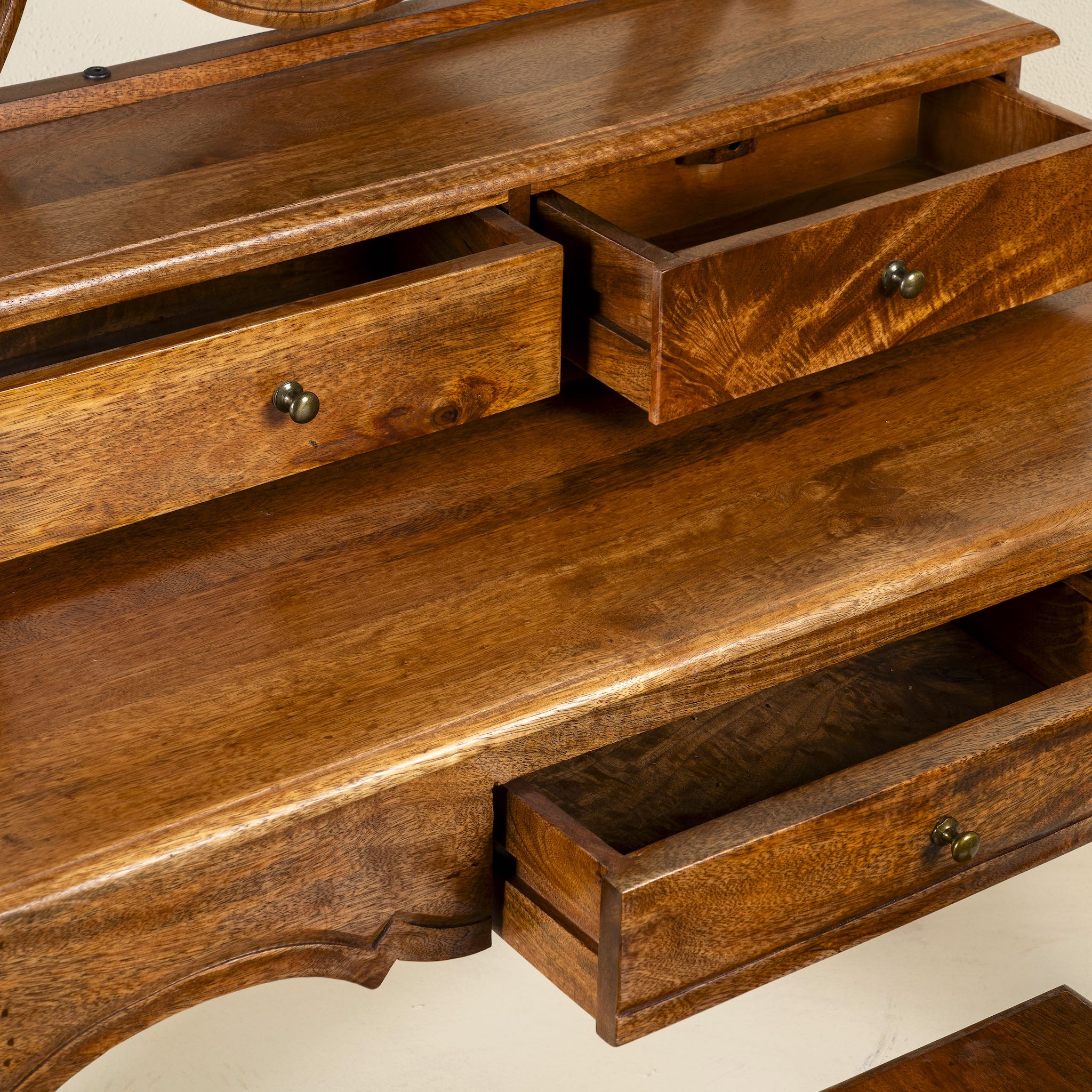 Close up image of a wooden dressing table with mirror and matching chair, handcrafted mango wood table with drawers; vintage bedroom furniture, 110 × 50 × 145 cm.