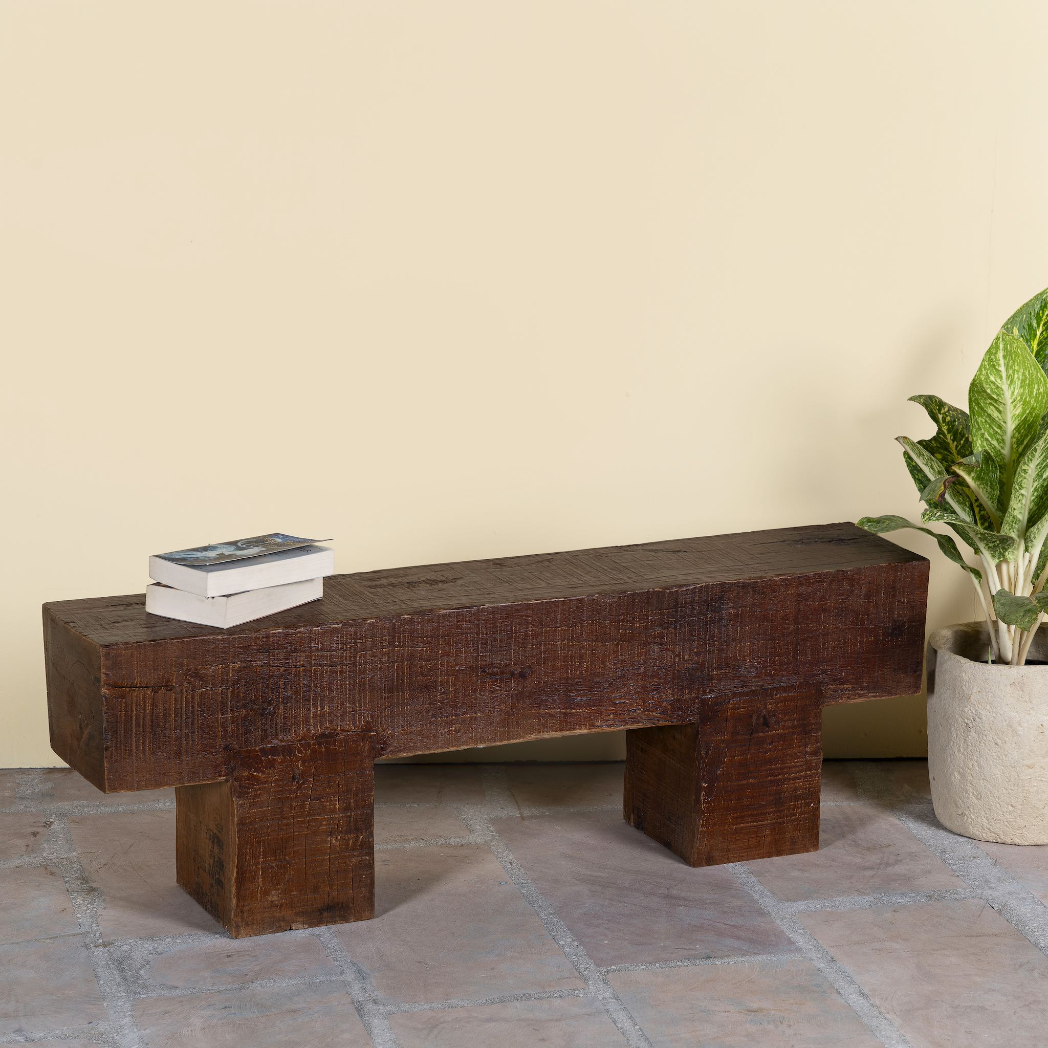 Side angle image of a rustic wood bench made of reclaimed wood, full block design, sustainable furniture for hallways, living rooms, or terraces, 200 × 30 × 40 cm.