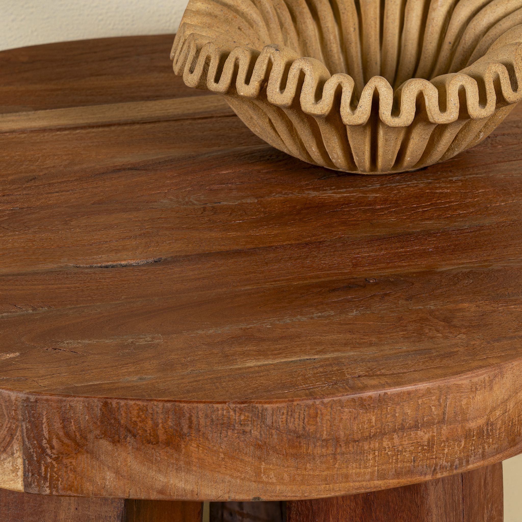 Close up image of a rustic wood coffee table with round reclaimed teak top and black charred finish; sustainable furniture, 70 cm diameter, 40 cm height.