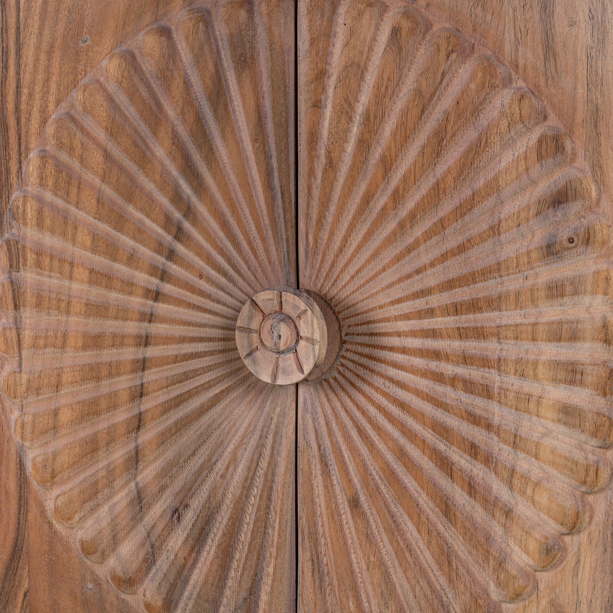 Close up image of a acacia wood cabinet with hand-carved sunburst doors, grooved details, and one drawer, 90 × 40 × 90 cm.
