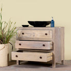 Image with open drawers of a reclaimed wood chest of 3 drawers with rustic finish and round knobs; Ibiza style sustainable furniture, 90 × 50 × 80 cm.