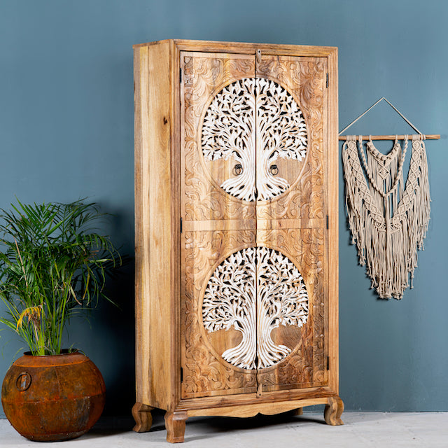 Side angle image of a artisanal Tree of Life furniture wardrobe with whitewashed carvings, handcrafted mango wood with four storage compartments, 90 × 40 × 180 cm.