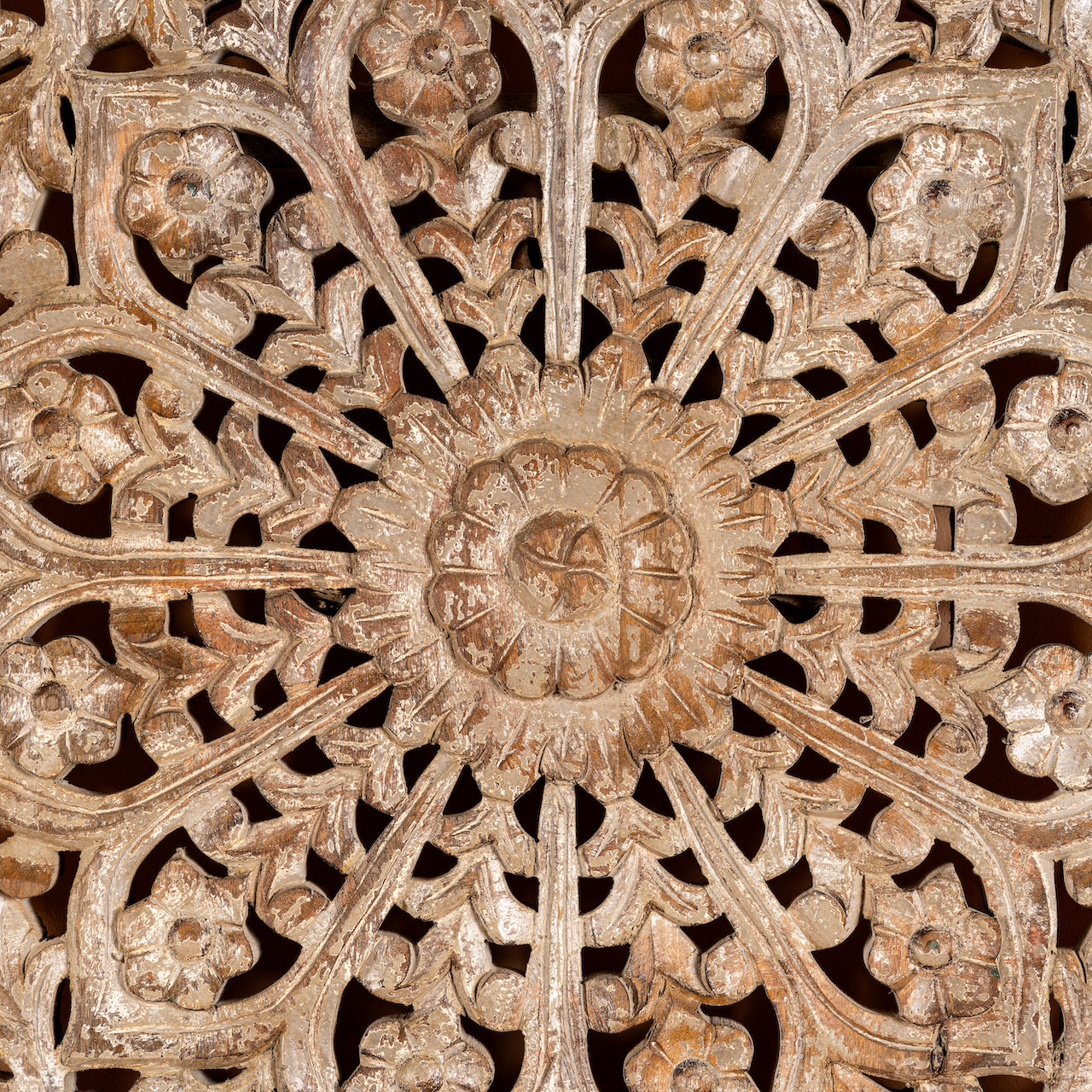 Close up image of a hand-carved whitewashed mango wood wall panel with floral design – Kataee model by Om Home & Garden