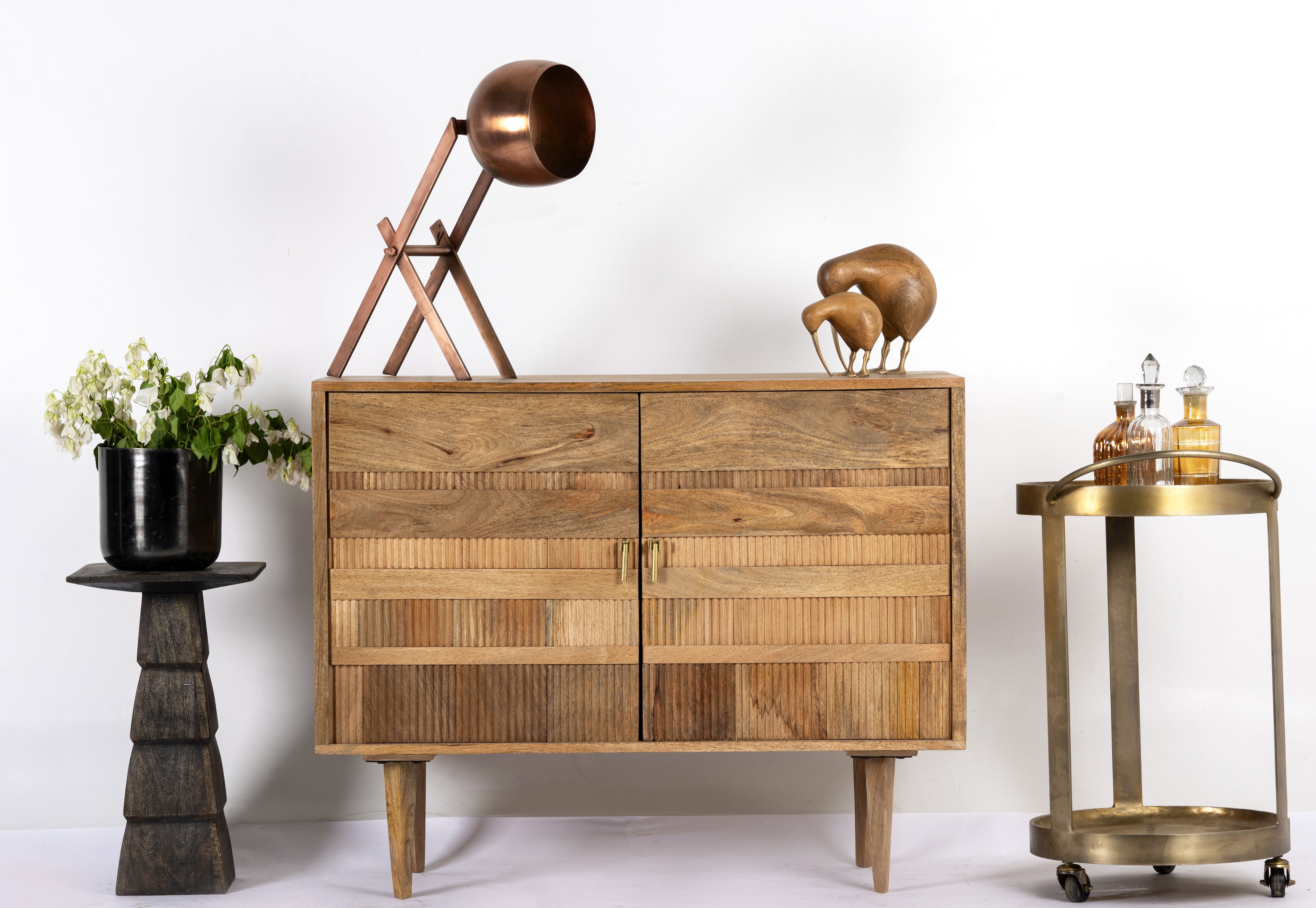 Hand-carved mango wood cabinet with 3D line-striped design and natural finish—vintage furniture blending artisanal detail and timeless style.