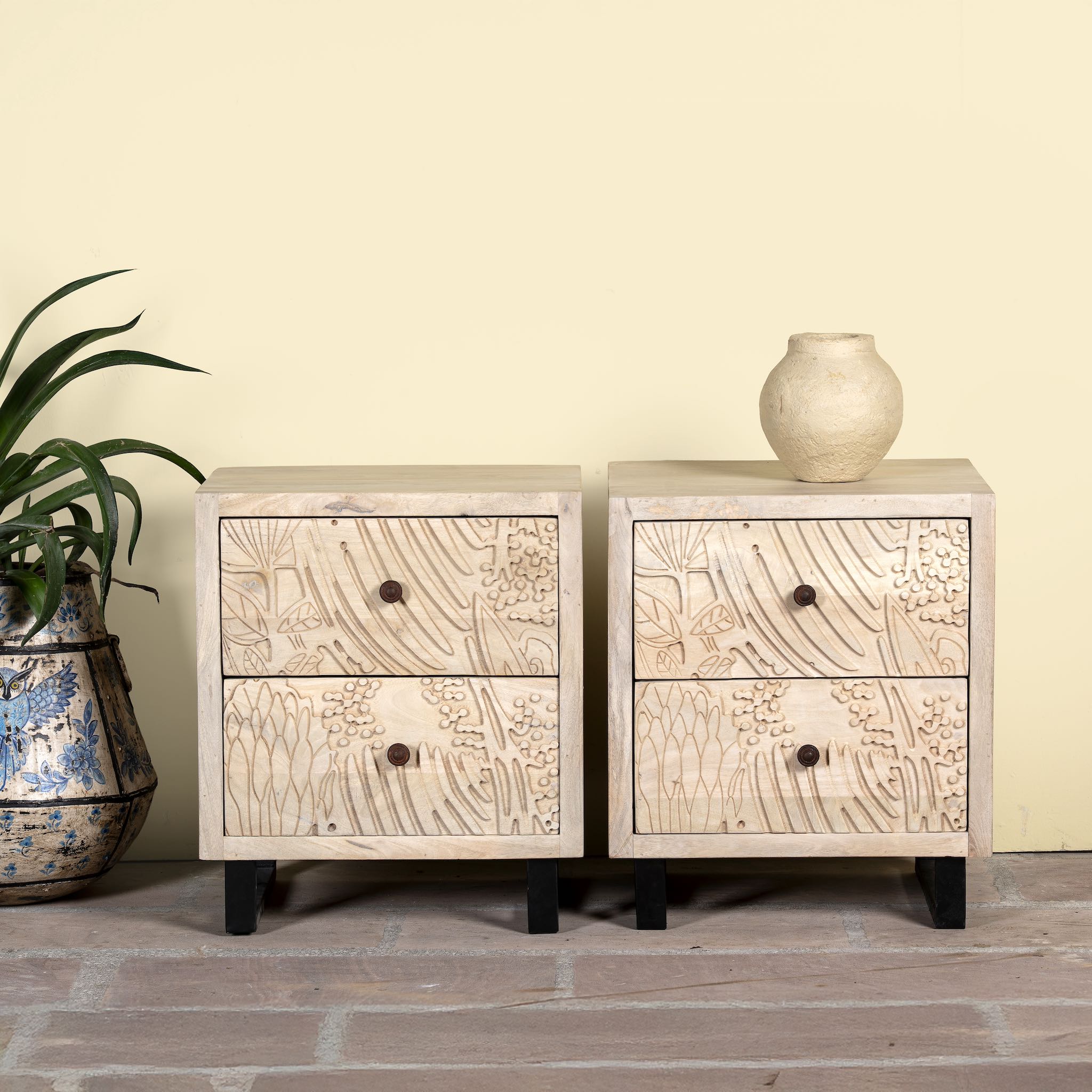 Pair of mango wood nightstands with hand-carved sandblasted finish and black iron stand; artisanal bedroom furniture, 51 × 41 × 59 cm.