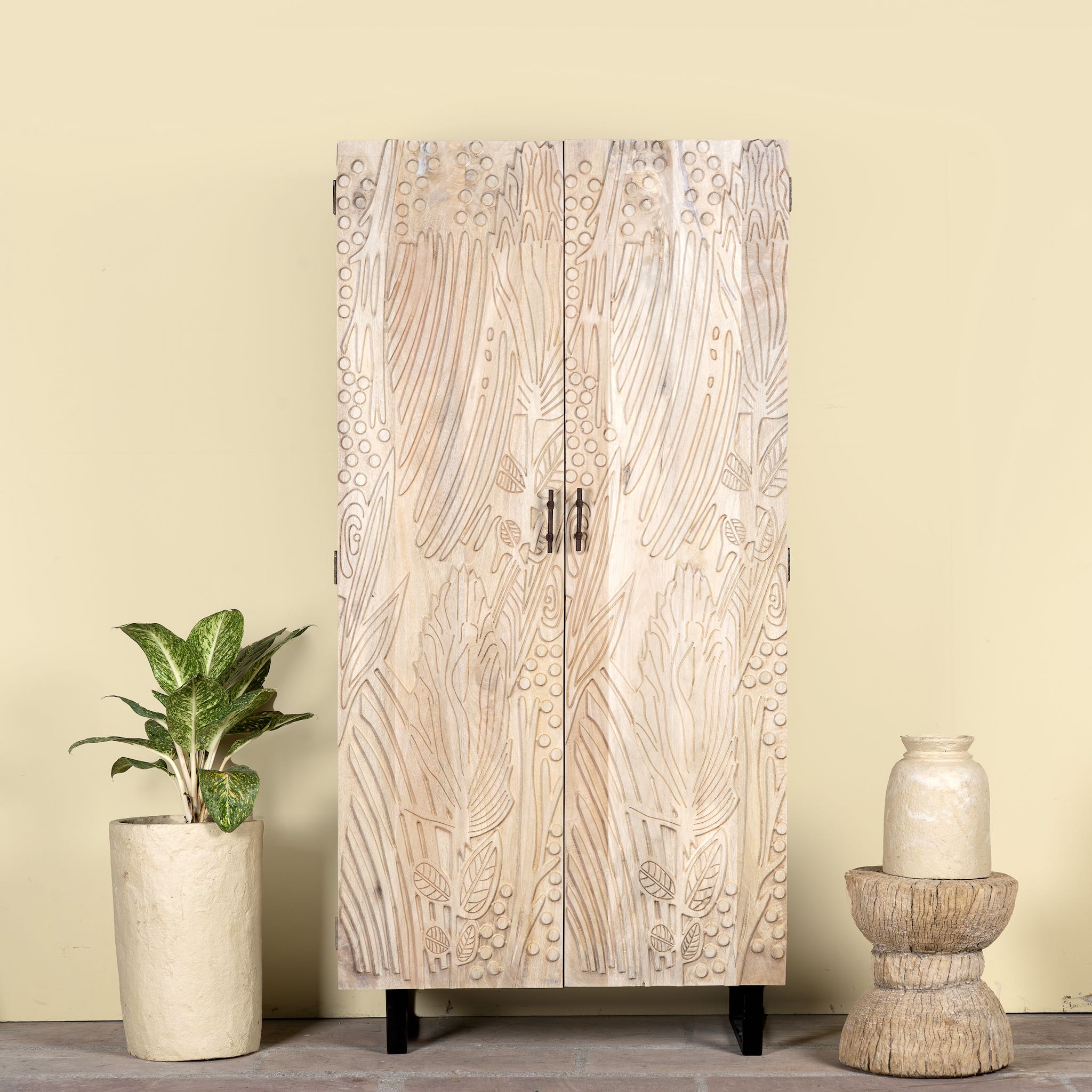 Hand-carved mango wood wardrobe with sandblasted finish and iron stand; artisanal bedroom furniture, 90 × 46 × 183 cm.