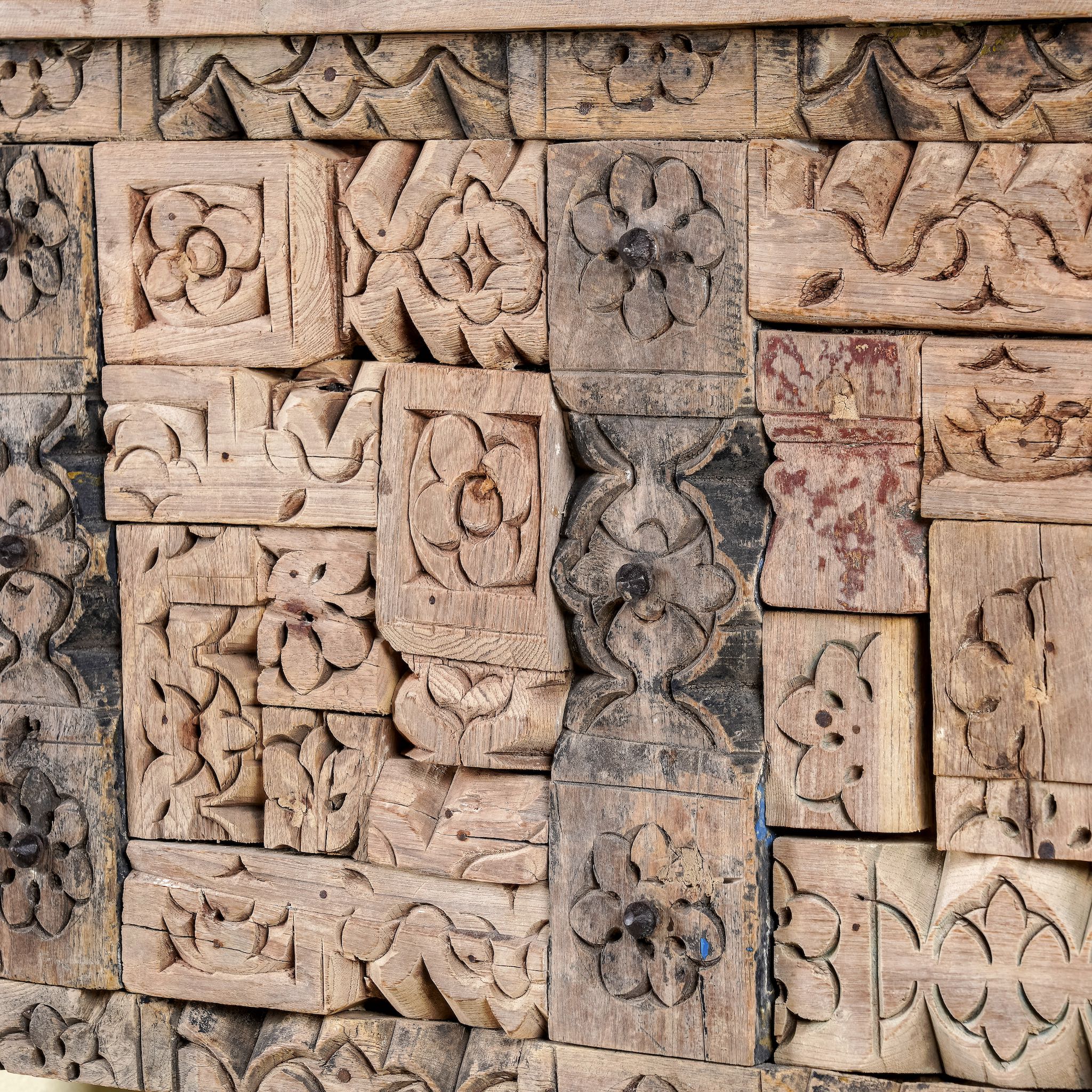 Close up image of a reclaimed teak console table with hand-carved antique elements and rustic finish, 140 × 38 × 93 cm.