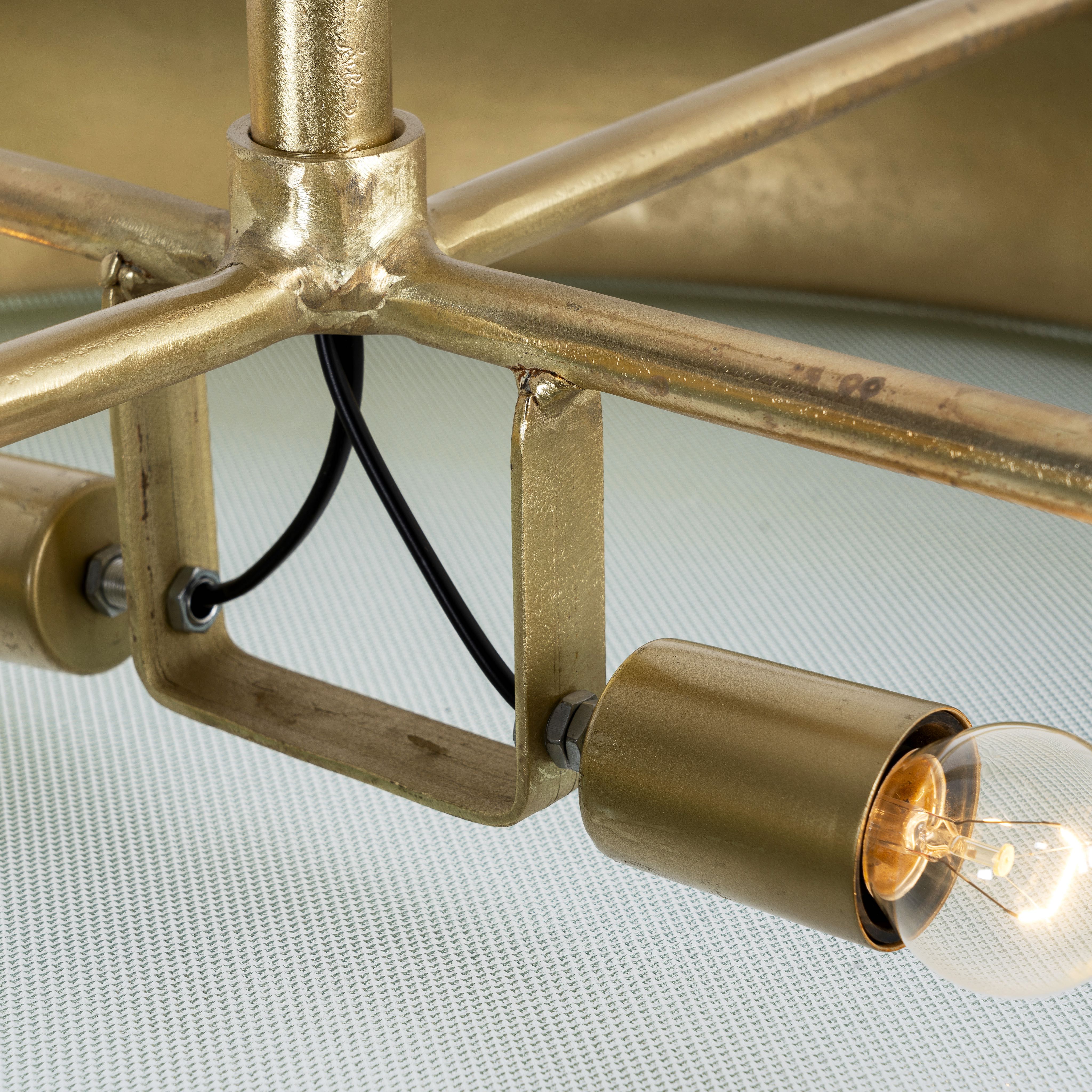 Close up image of a large round pendant lamp with clear hand-blown glass and brass-plated iron frame – retro lighting and artsy lamp ideal for kitchens, living rooms, or dining areas.