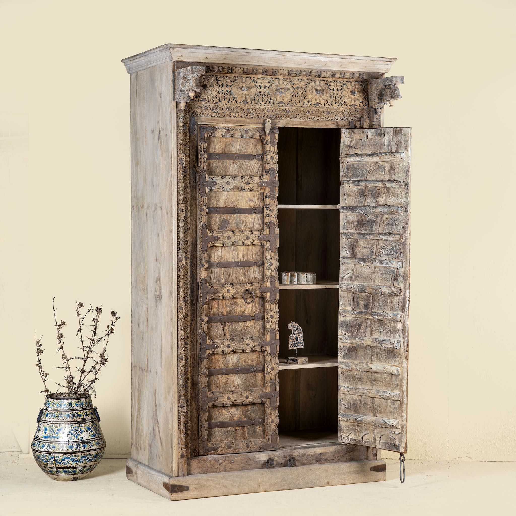 Open door image of Mahika cabinet with antique carved teak door, part of our teak wood furniture collection, perfect for a bohemian interior.