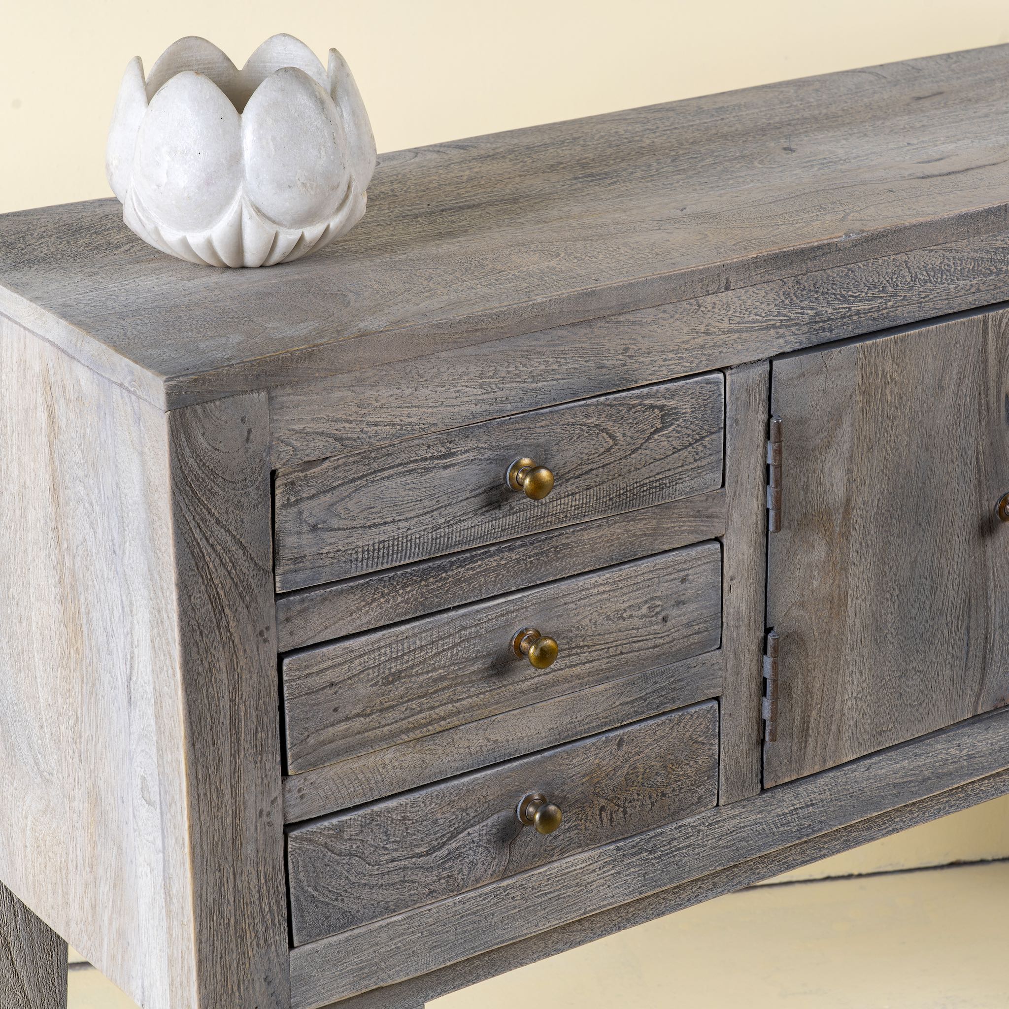 Close up picture of a elegant wooden console table  with drawers and doors, ideal as an entryway table vintage statement piece.