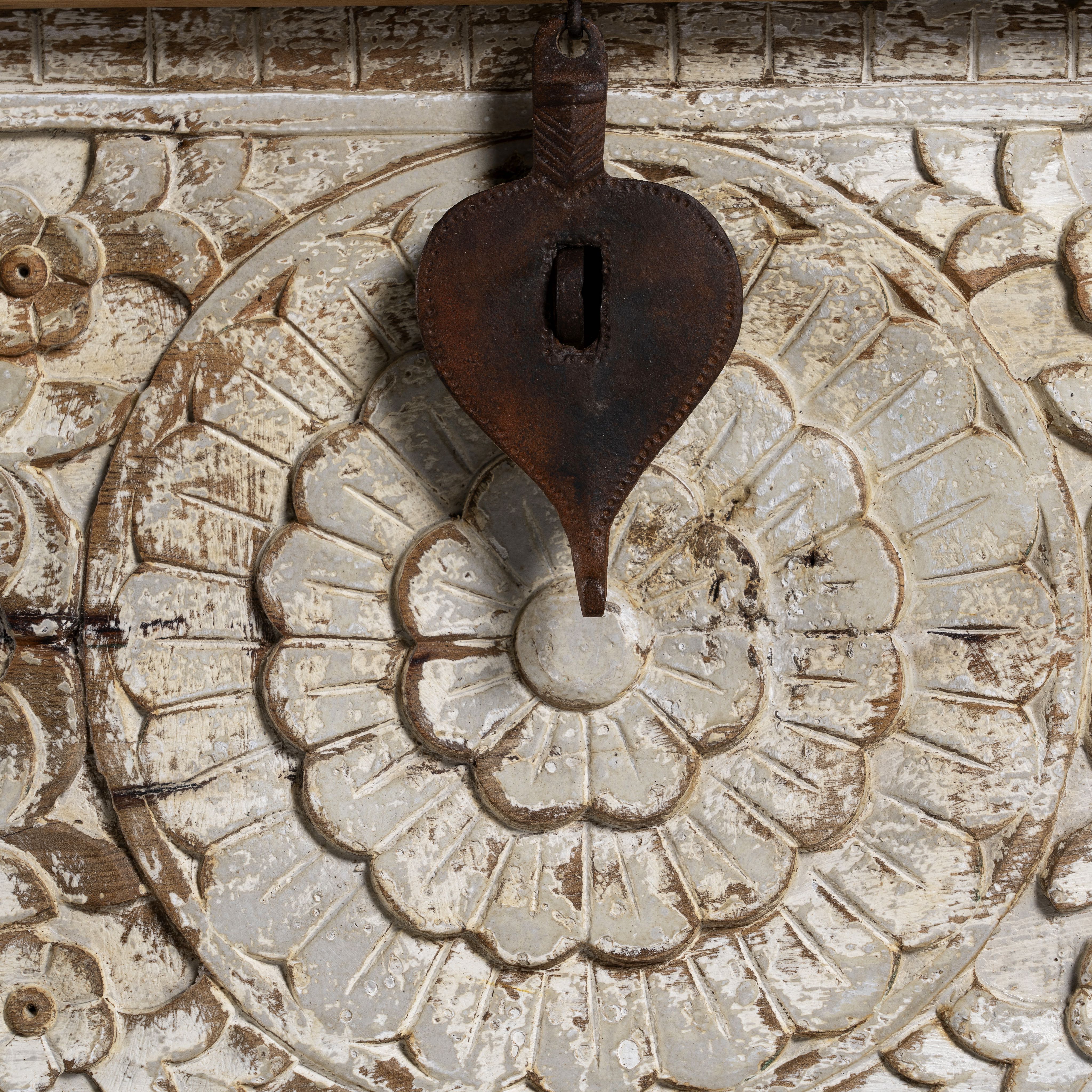 Close up image of a hand-carved mango wood chest box with floral motifs, whitewashed finish, and iron handles – vintage home accessory for rustic and elegant interiors.