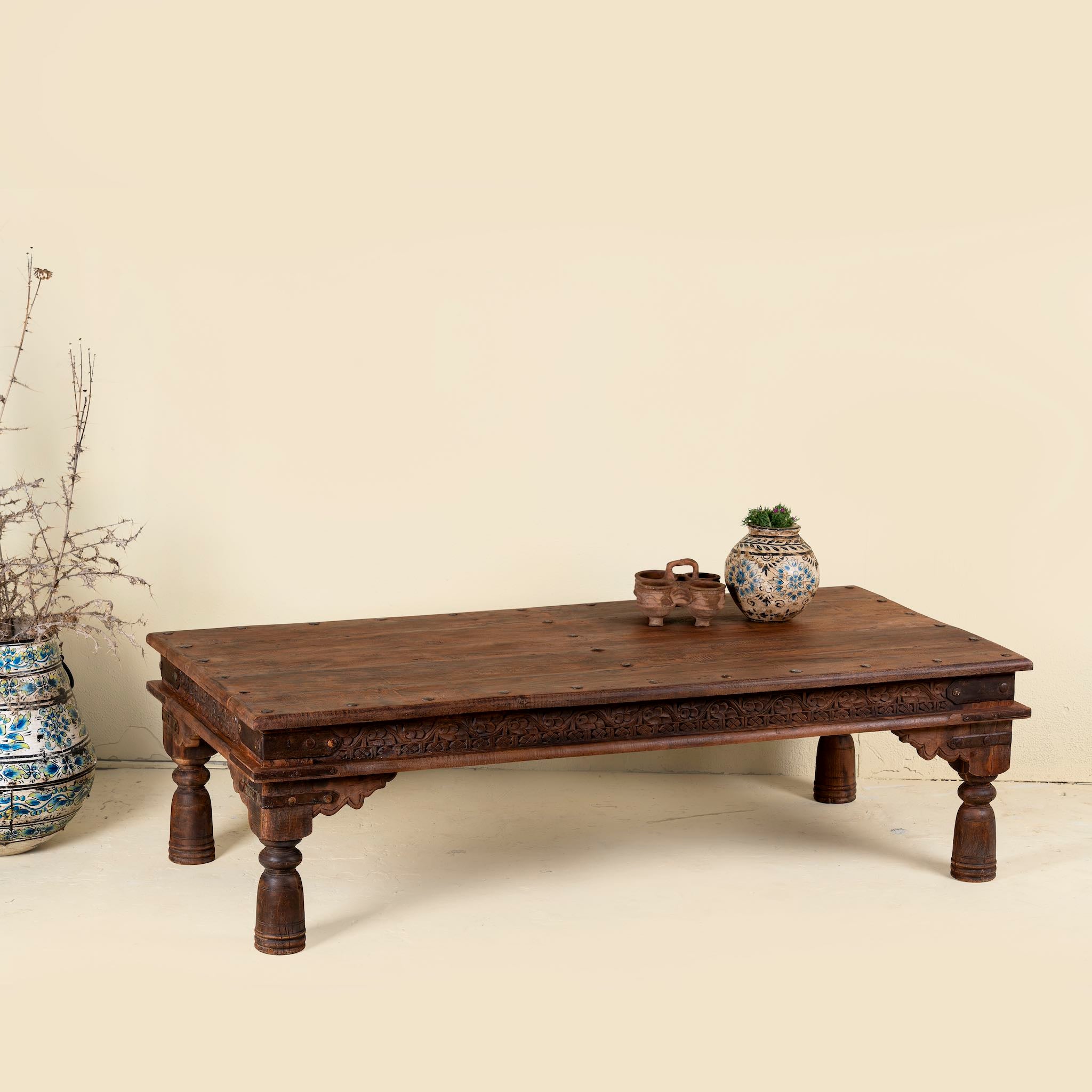 Rectangular teak wood coffee table with hand-carved Indian detailing, reclaimed wood finish, and iron accents; 158 × 76 × 46 cm.