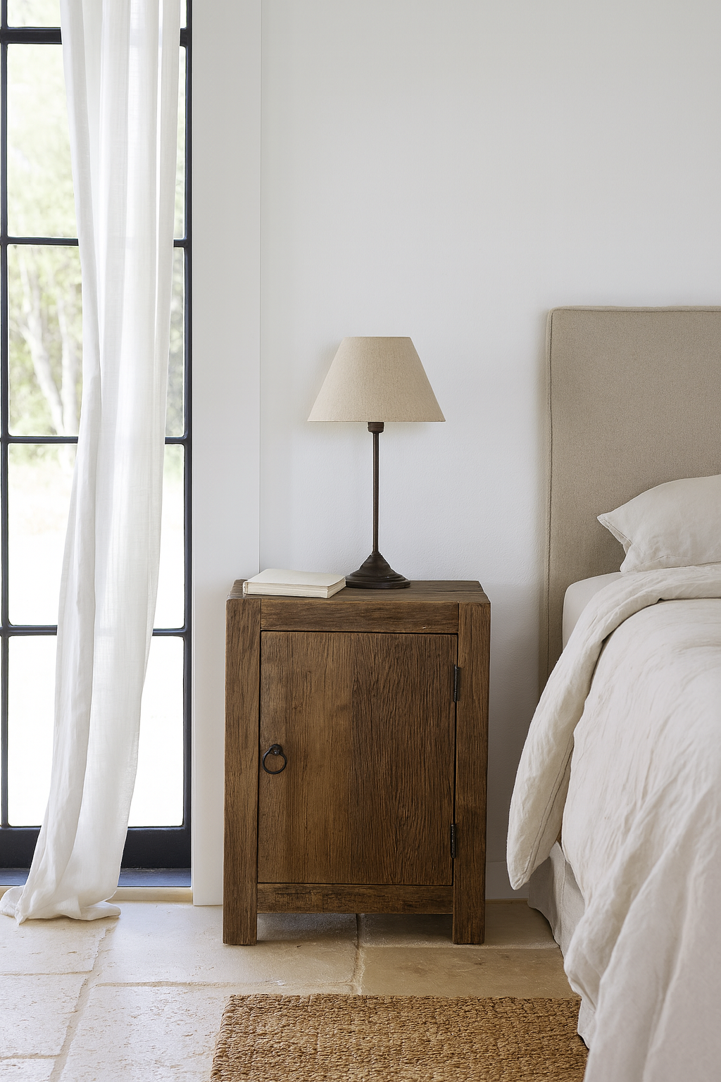 Lifestyle scene with a reclaimed wood bedside table with single cabinet door – handcrafted driftwood furniture ideal for rustic minimalism and natural interior styling.