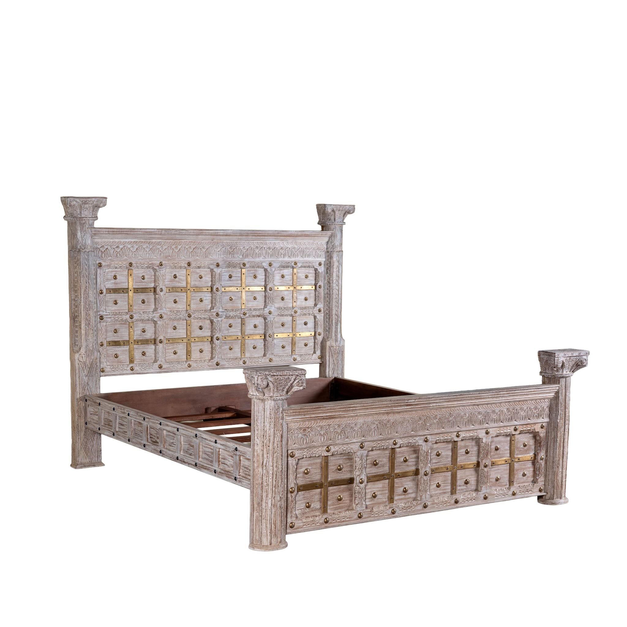 Side angle white background image of a handcrafted four poster bed made from reclaimed wood with carved detailing – Mirai model by Om Home & Garden