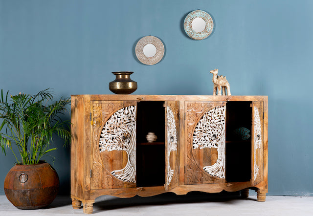 Side angle image with open doors of a hand-carved mango wood sideboard with Tree of Life motif, whitewashed finish, and four storage compartments; artisanal mango wood furniture for dining rooms, entryways, or living areas, 180 × 90 × 40 cm.