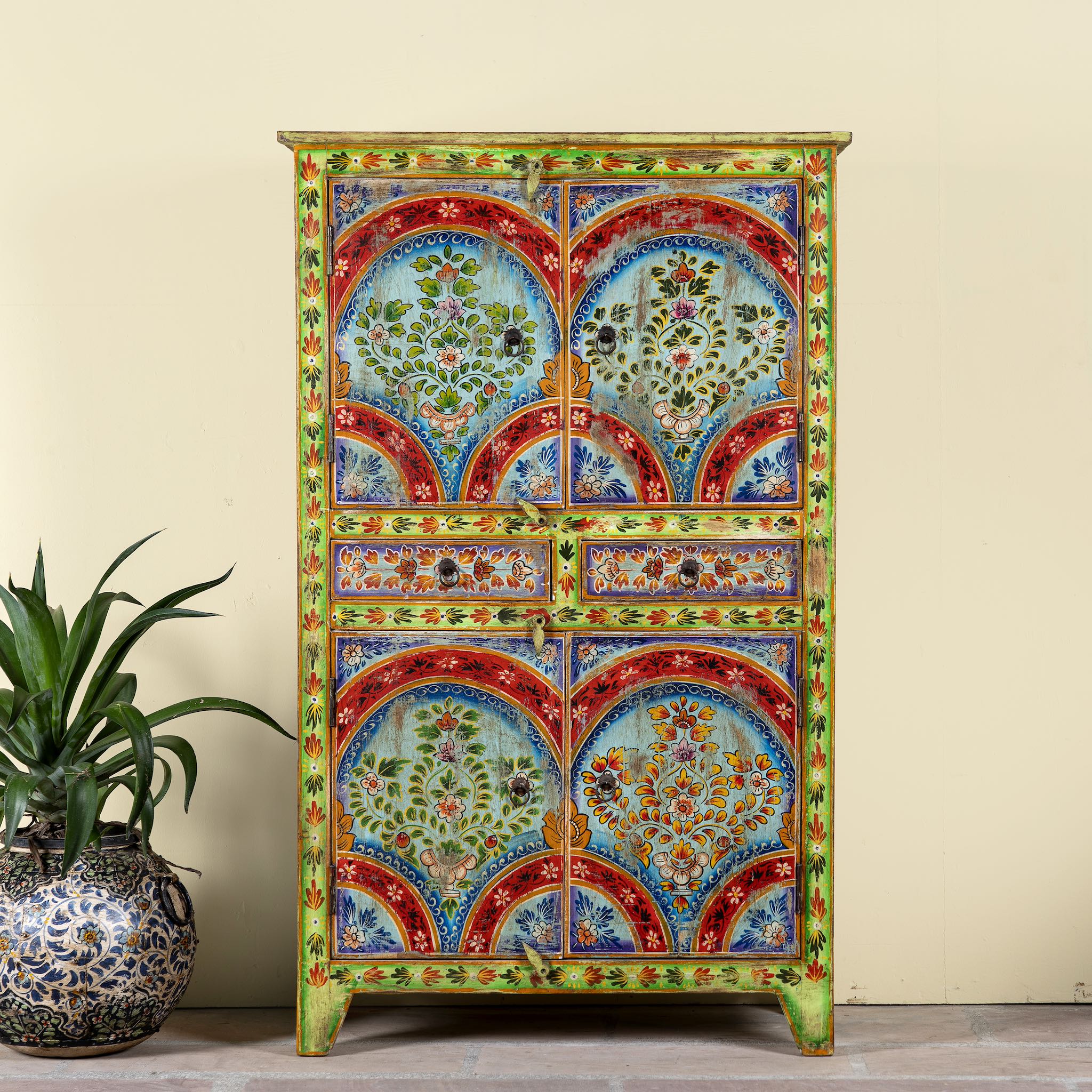 Hand-painted cabinet made from reclaimed wood with colourful floral motifs – a sustainable furniture piece ideal for expressive Indian home decor.