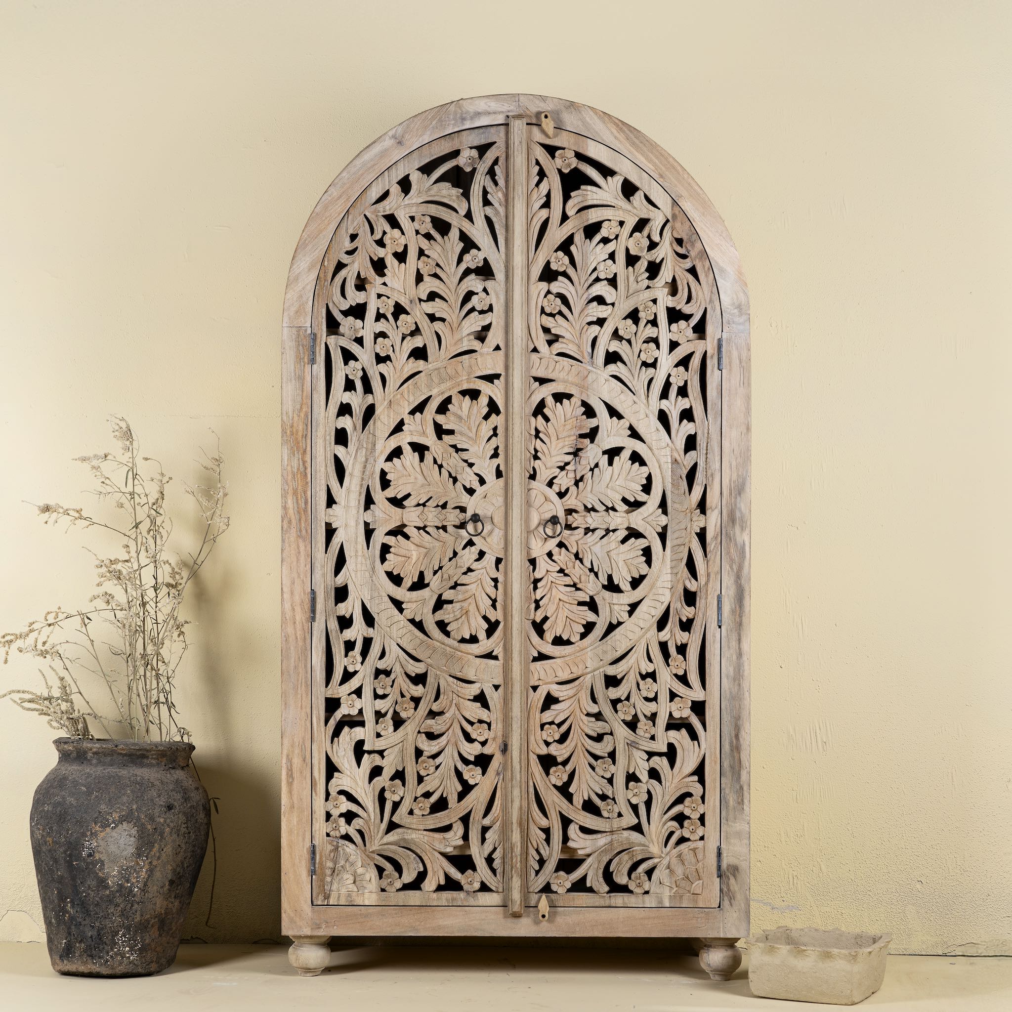Hand-carved mango wood wardrobe, a statement piece of bedroom furniture ideal for a bohemian interior.