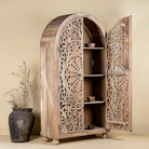 Open door image of a hand-carved mango wood wardrobe, a statement piece of bedroom furniture ideal for a bohemian interior.