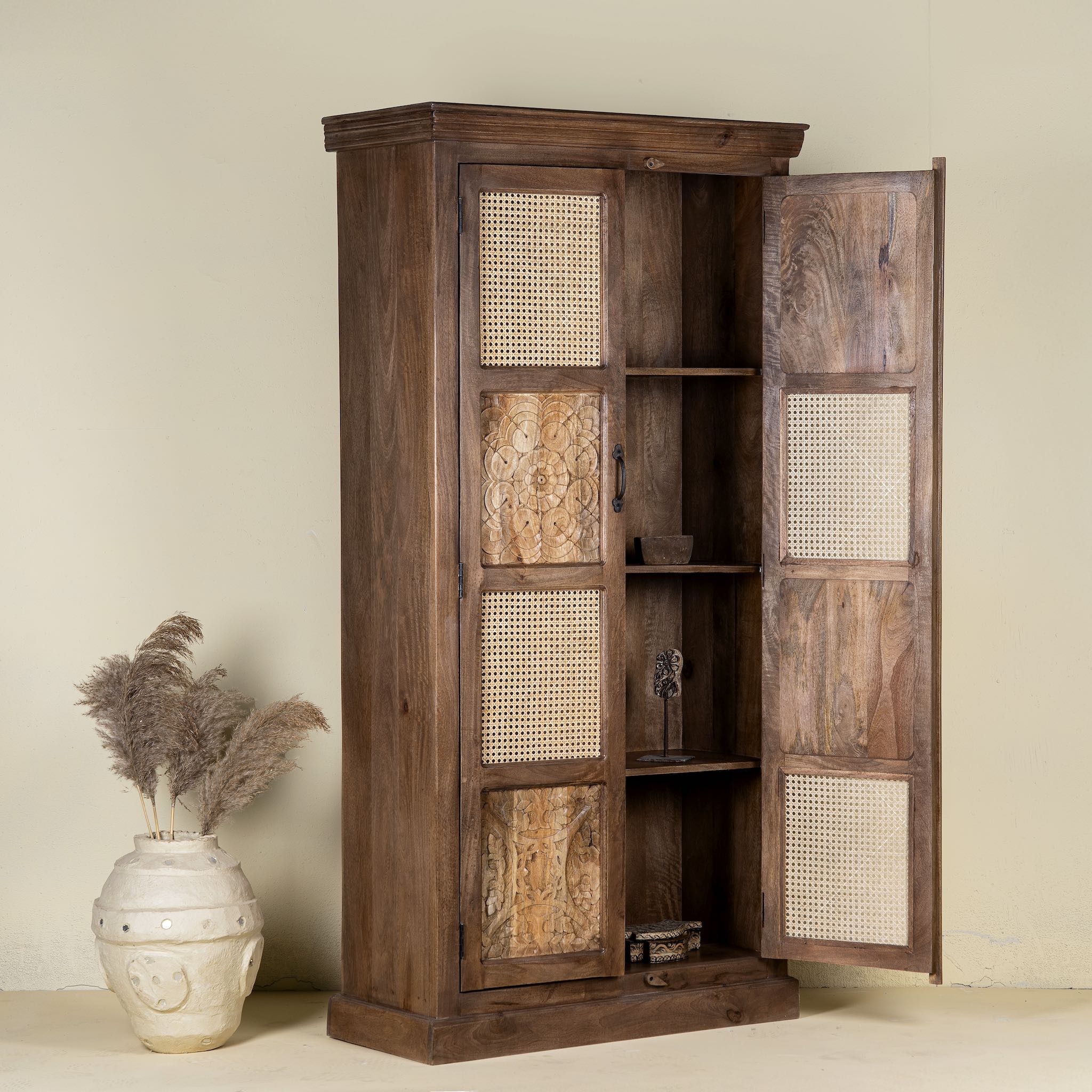 Open door image of a tall mango wood furniture cabinet with hand-carved details and woven rattan doors, artisan rattan furniture, 90 × 40 × 180 cm.