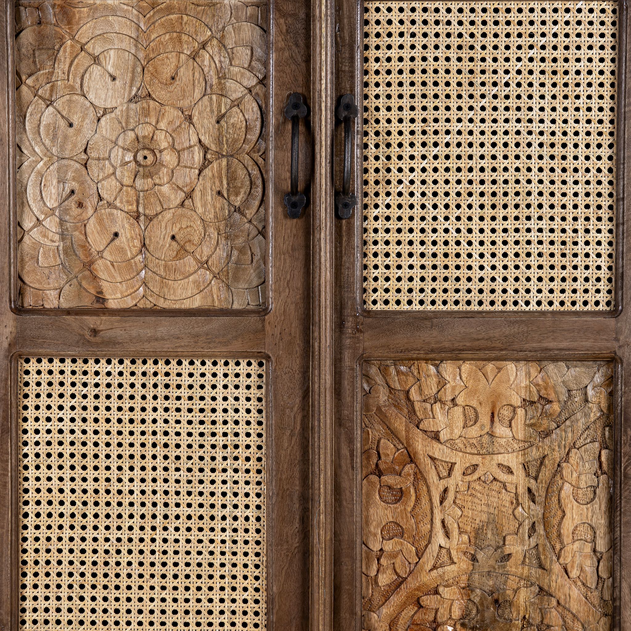 Close up image of a tall mango wood furniture cabinet with hand-carved details and woven rattan doors, artisan rattan furniture, 90 × 40 × 180 cm.