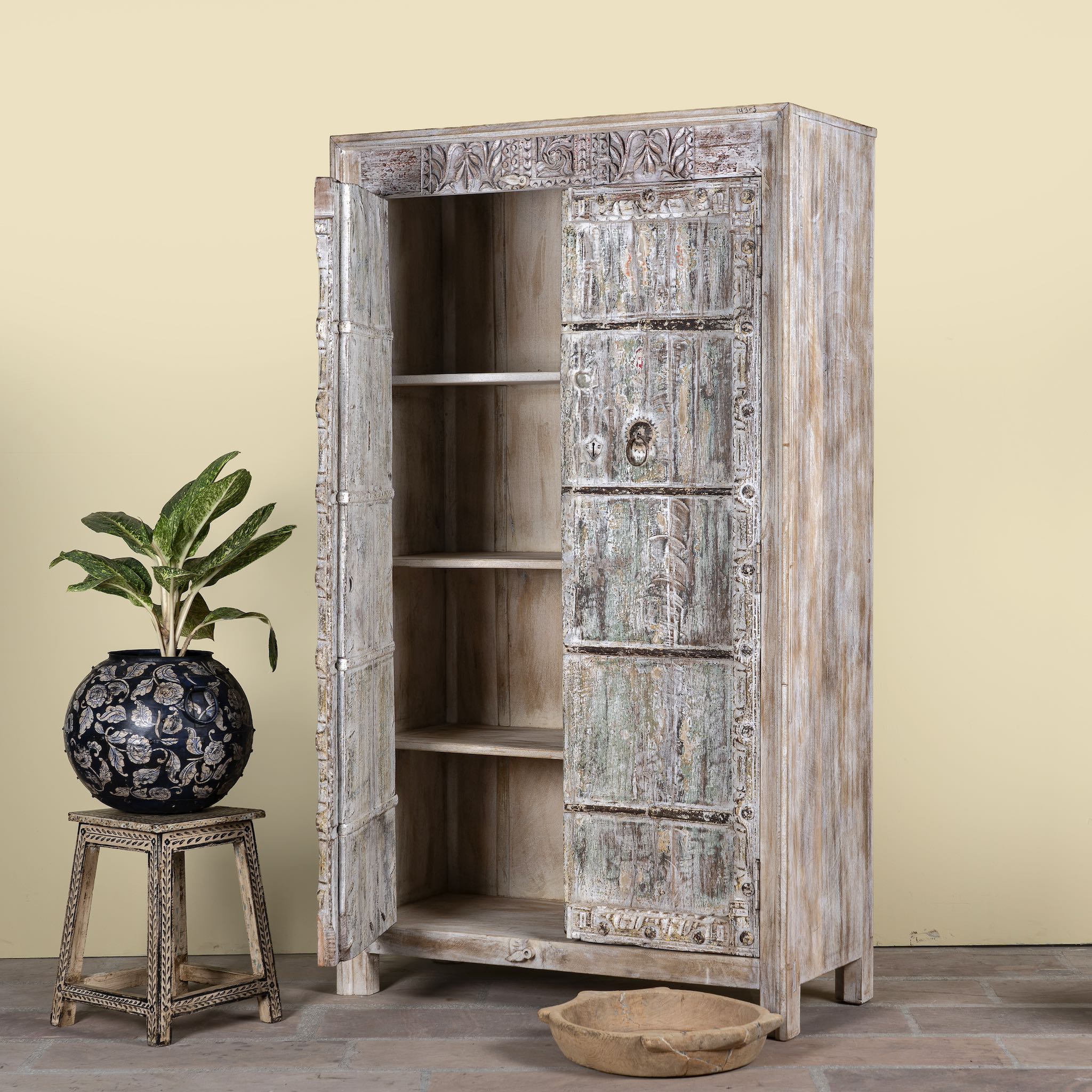 Side angle image with open door of a reclaimed wood wardrobe made with antique door panels – a handcrafted piece of old door furniture perfect for Indian home decor and rustic interiors.