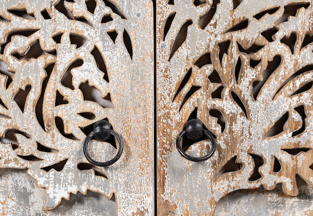 Close up image of a Mango wood cabinet under sink with carved tree design on front, 90 × 80 × 40 cm.